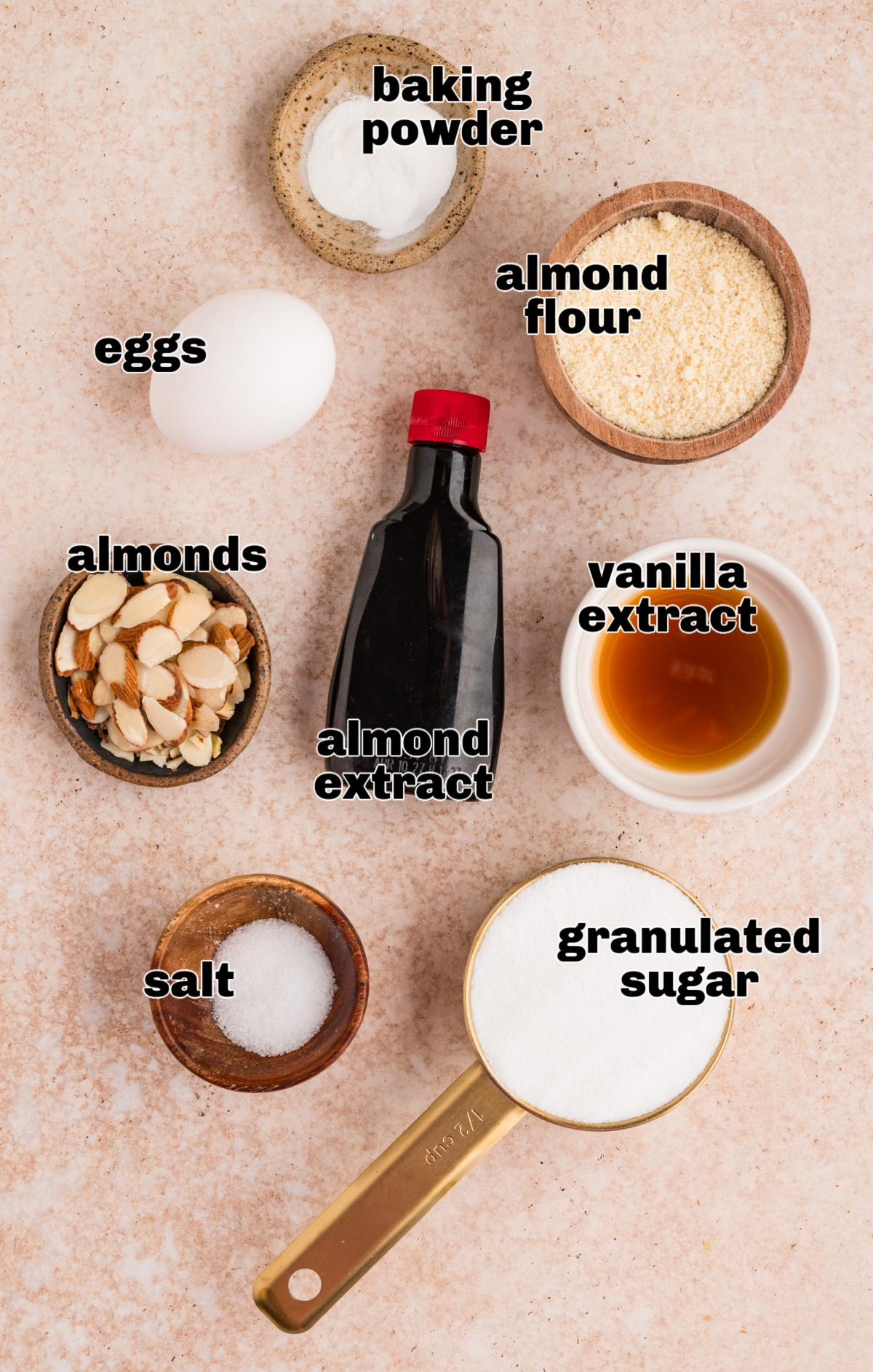 Ingredients for almond cake including almond flour, eggs, sugar, baking powder, sliced almonds, vanilla extract, almond extract, and salt