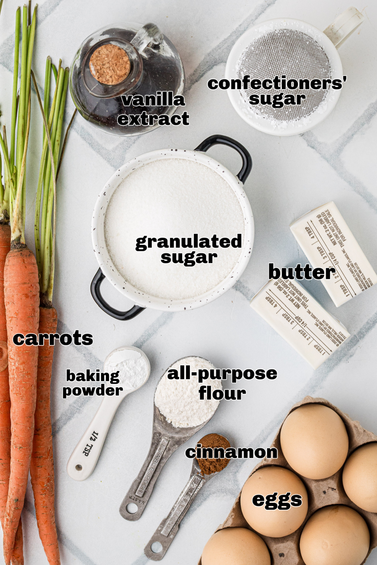 Ingredients for carrot casserole including carrots, eggs, sugar, butter, flour, baking powder, cinnamon, vanilla extract, and confectioners' sugar