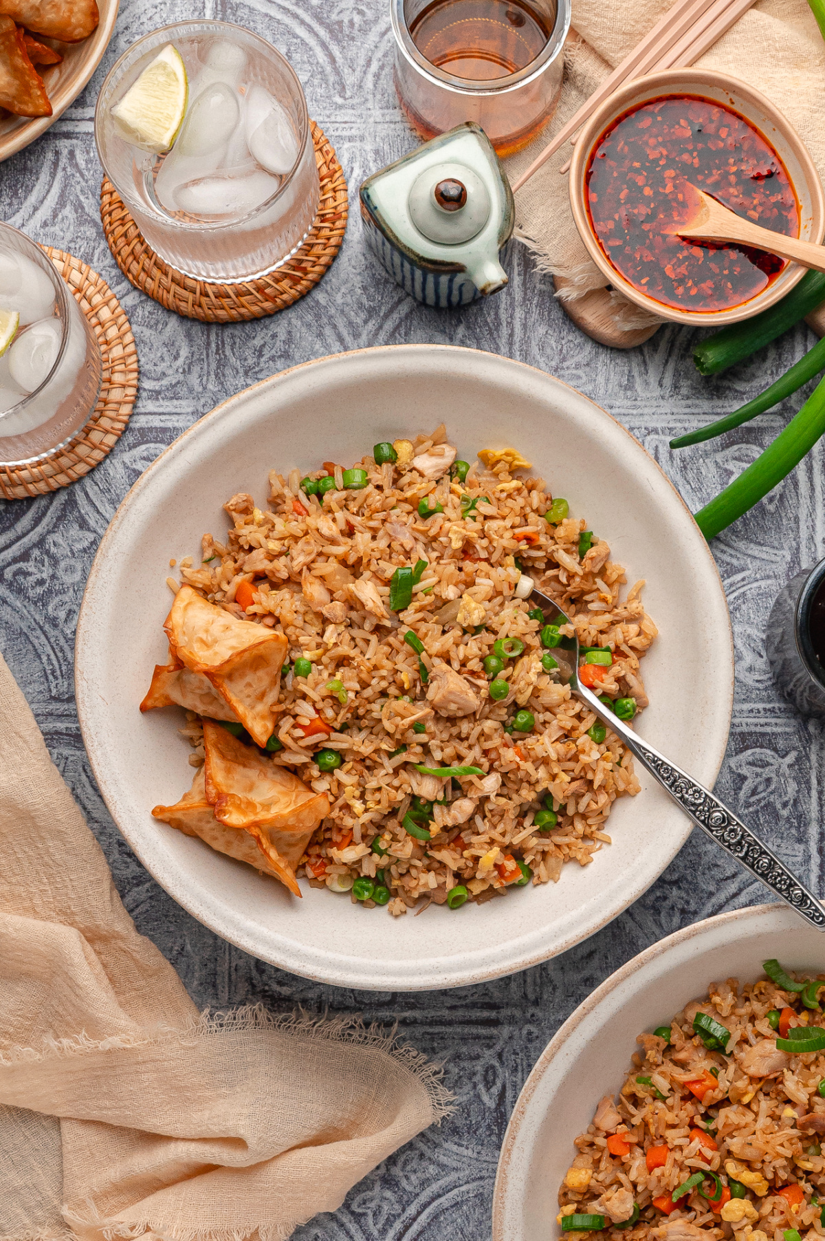 Fried rice with rotisserie chicken, eggs, peas, carrots, and green onions served with crispy wontons