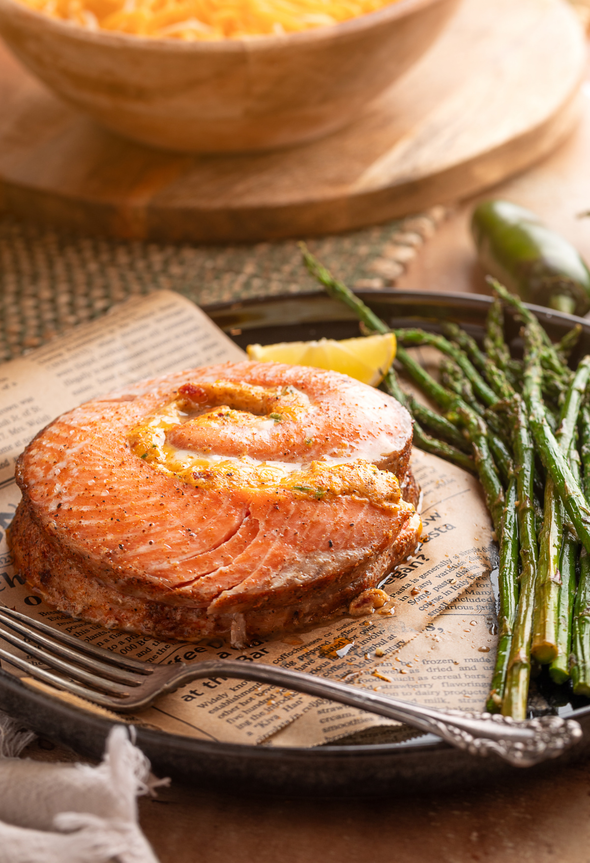Chipotle jalape&ntilde;o popper stuffed salmon rolls baked and served with roasted asparagus