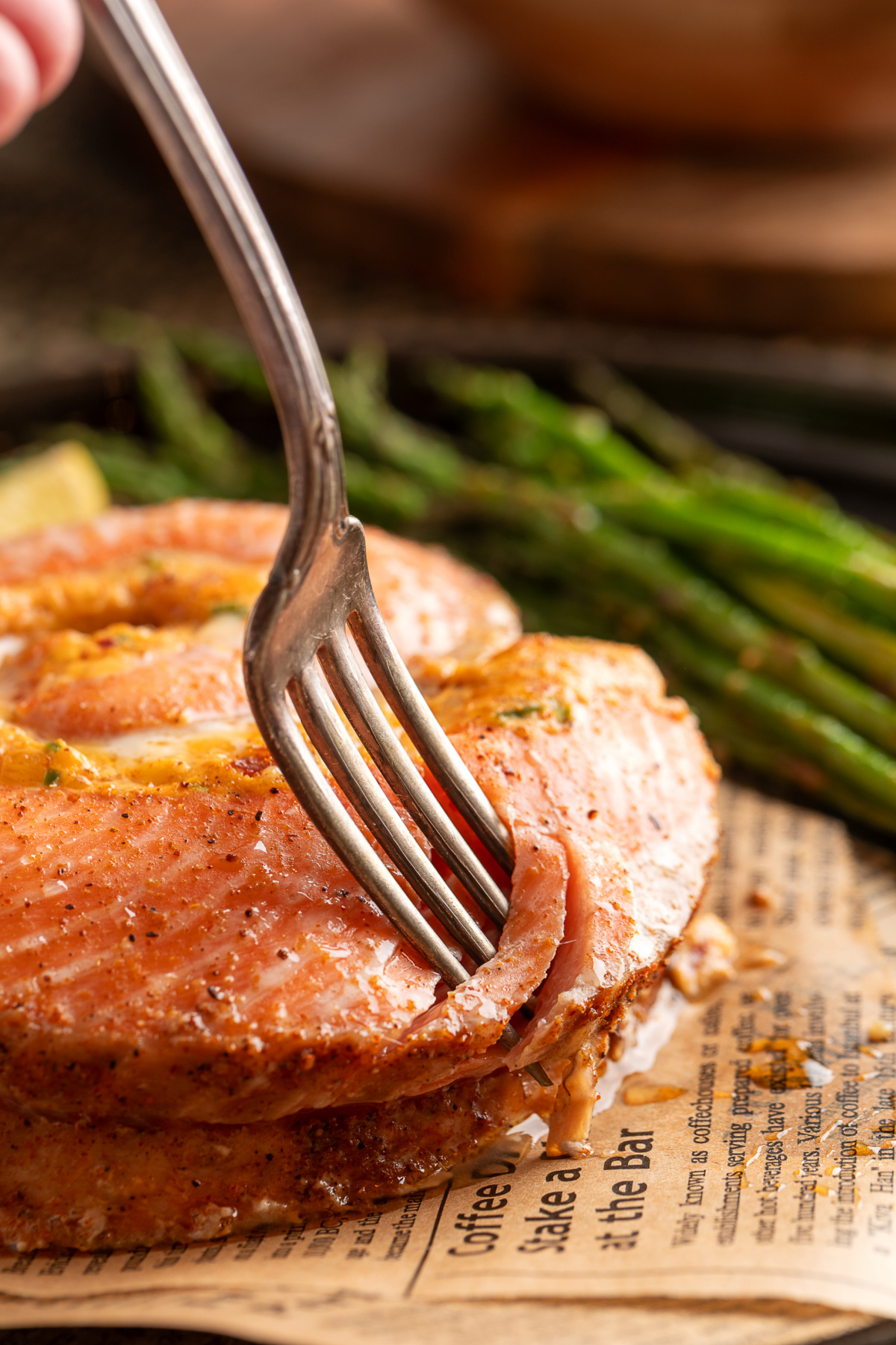 Fork cutting into a baked salmon pinwheel with creamy jalape&ntilde;o popper filling