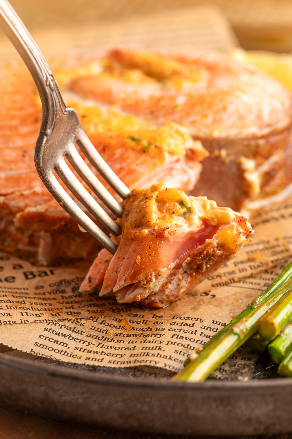 Chipotle jalape&ntilde;o popper stuffed salmon rolls with a fork lifting a flaky bite