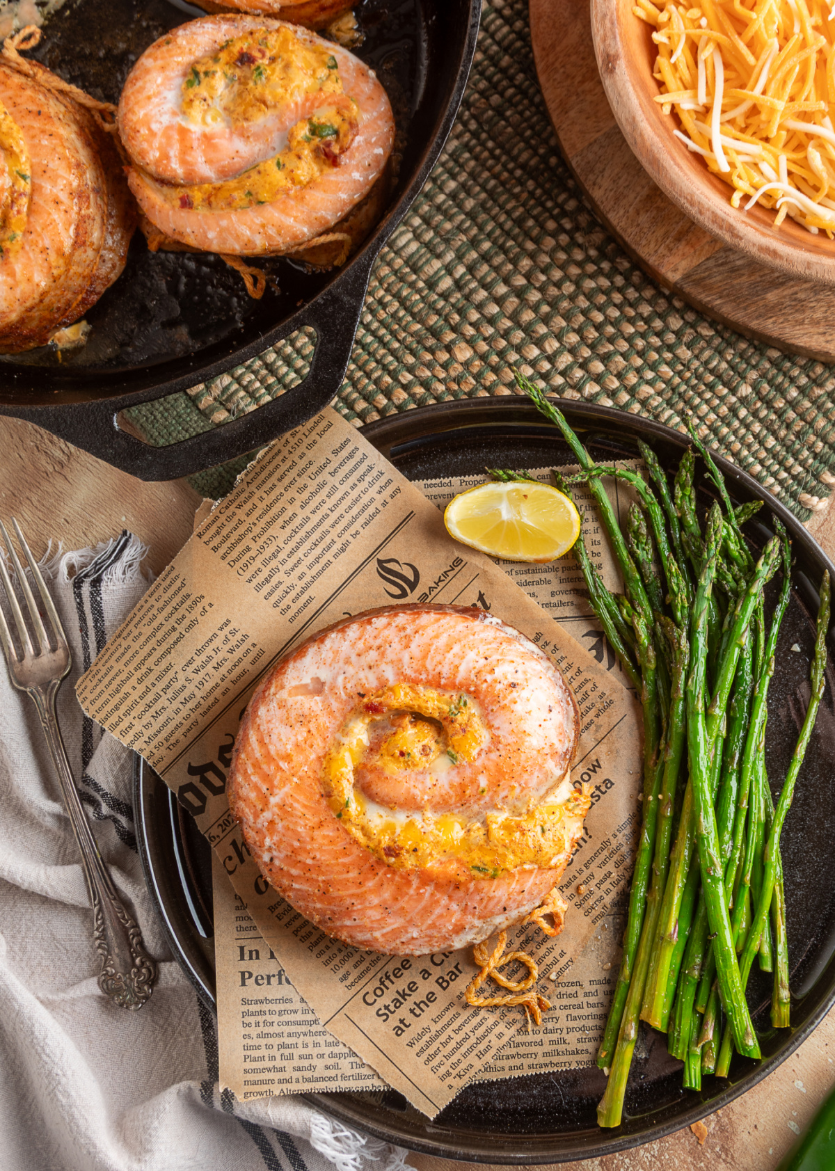 Chipotle jalape&ntilde;o popper stuffed salmon rolls baked in a cast iron skillet and plated for serving