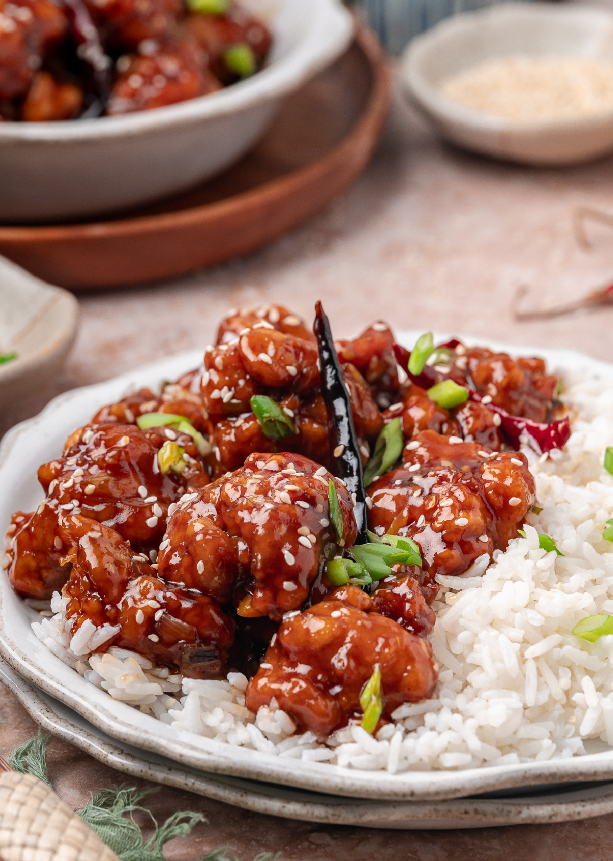 Crispy Chinese-American chicken served over steamed rice with scallions and sesame seeds