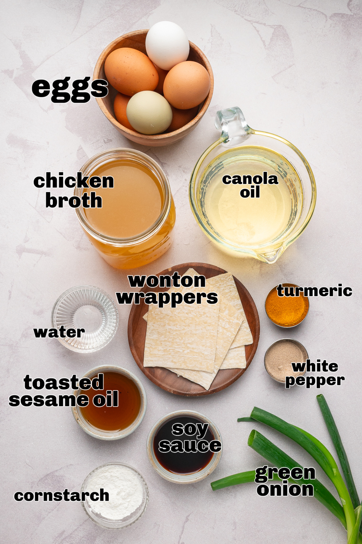 Egg drop soup ingredients including eggs, chicken broth, wonton wrappers, and seasonings