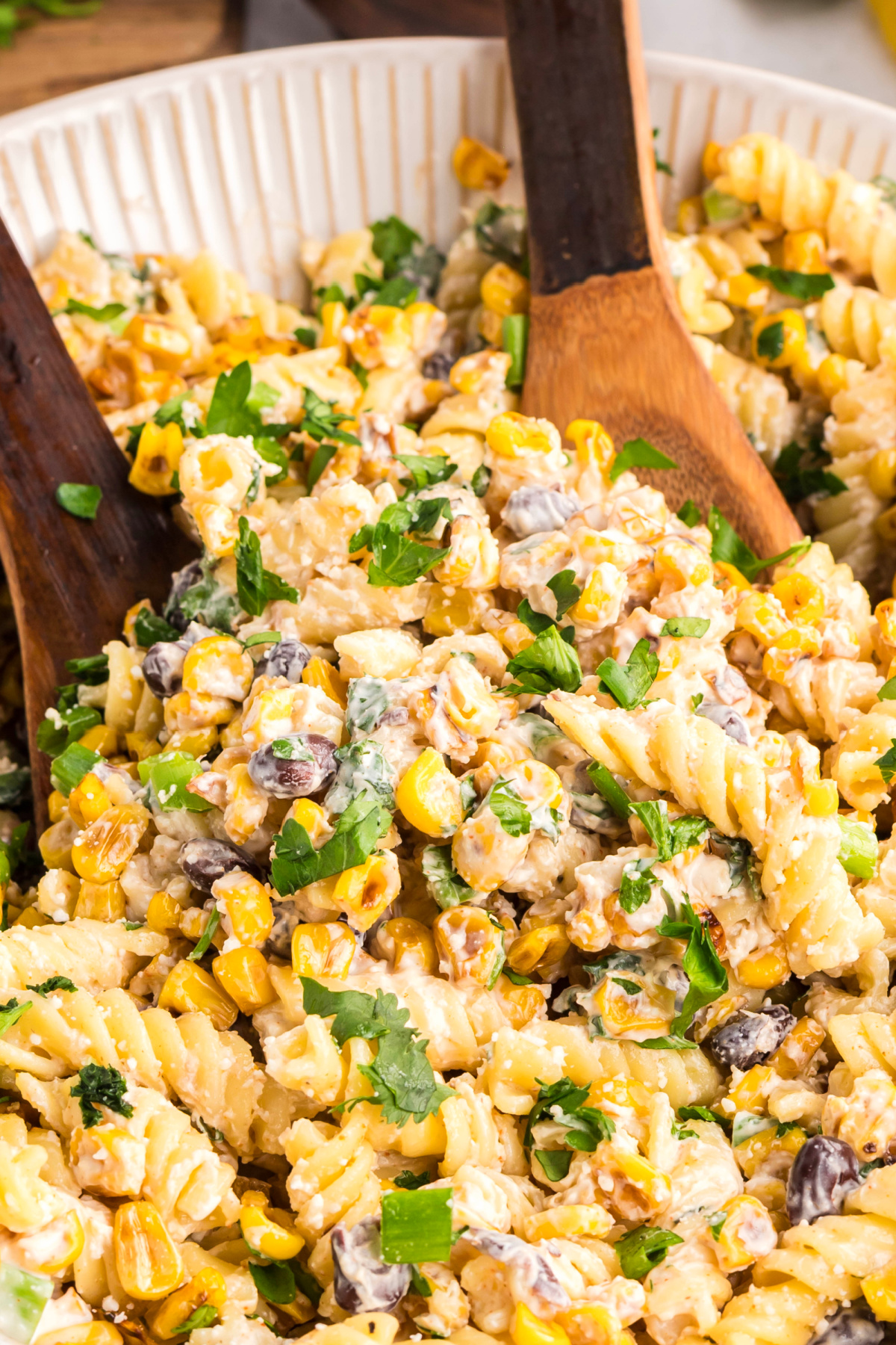 Creamy elote-style pasta salad with roasted corn, rotini, black beans, and fresh herbs