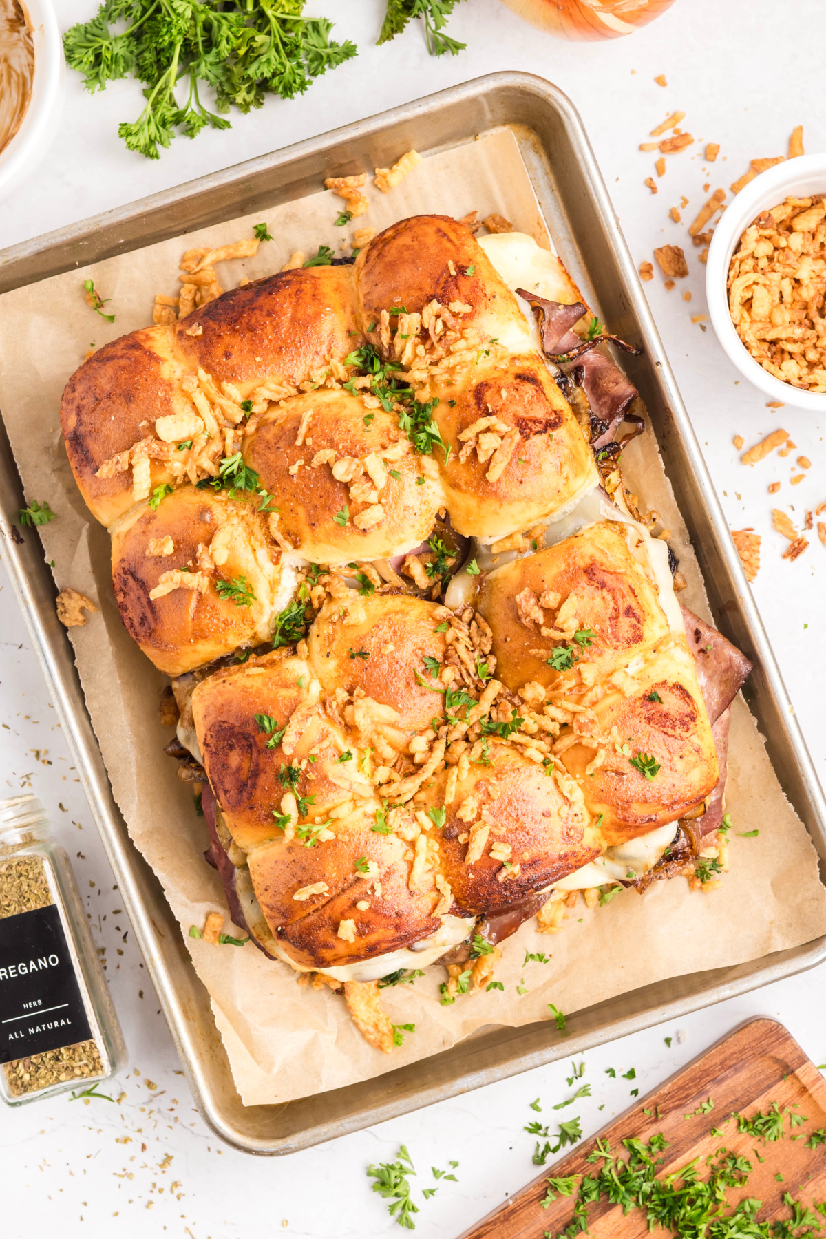 Baked roast beef sliders with provolone, caramelized onions, and French-fried onions on sweet rolls