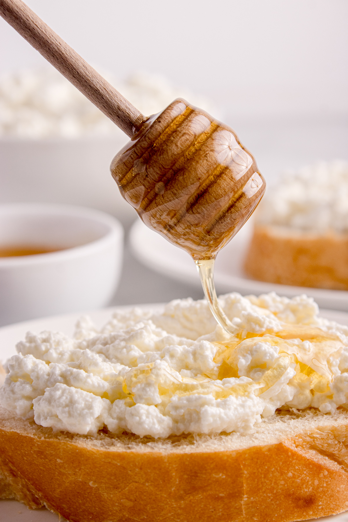 Homemade ricotta cheese spread on toasted bread with honey drizzle