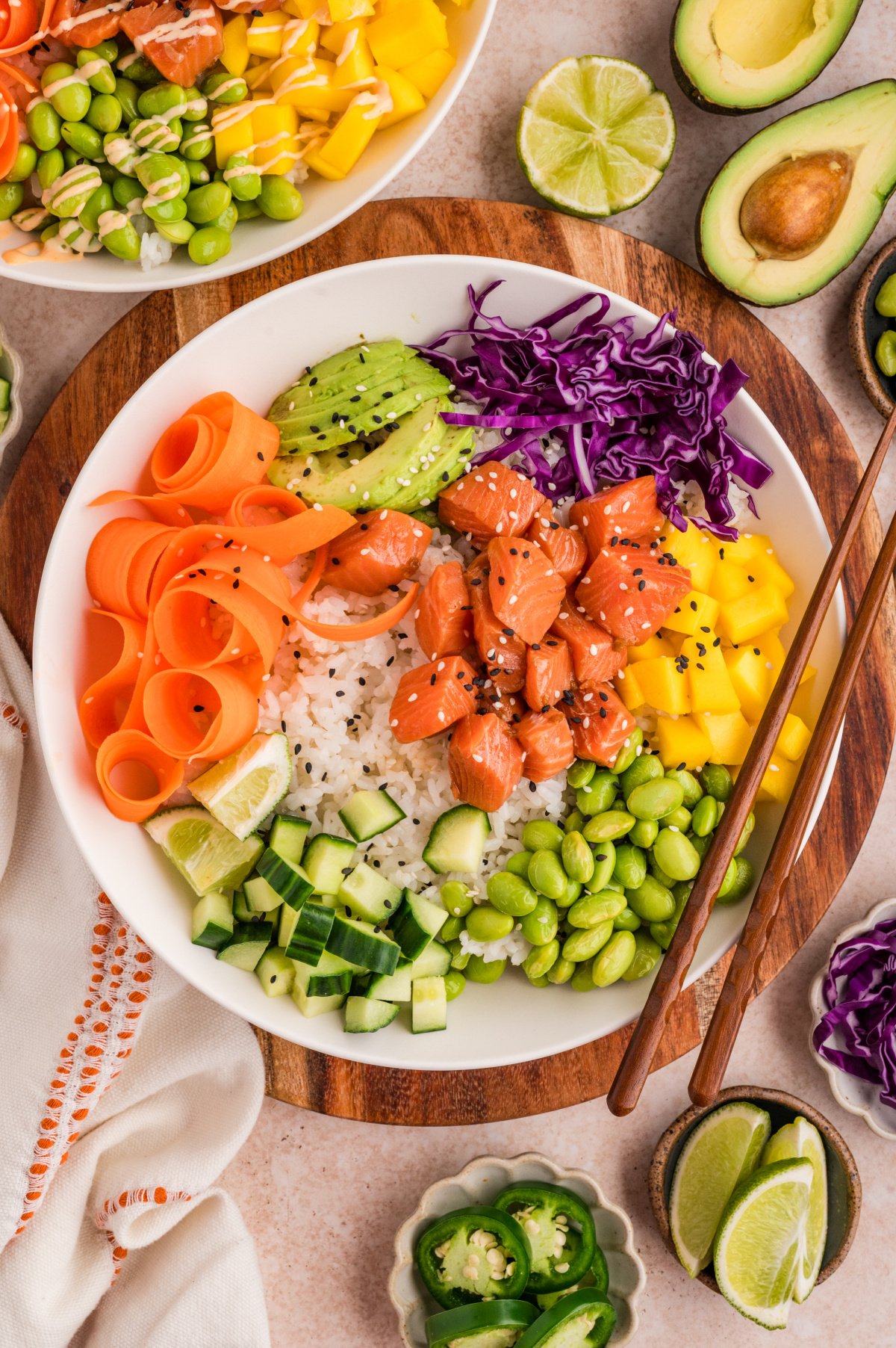 Salmon poke bowls with marinated raw salmon, sushi rice, mango, avocado, and fresh vegetables