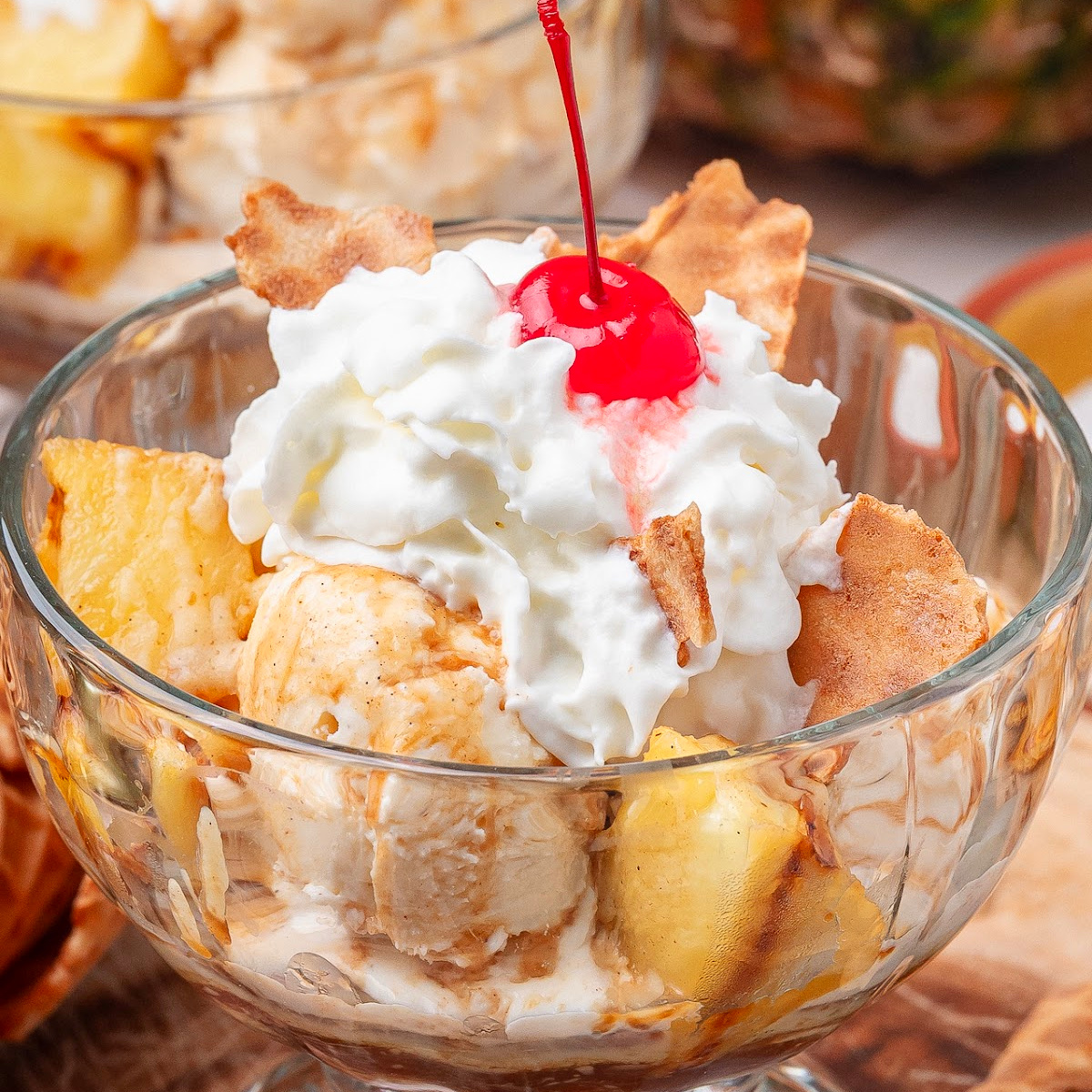 Grilled Pineapple Sundaes with Hot Buttered Rum Sauce and caramelized pineapple chunks