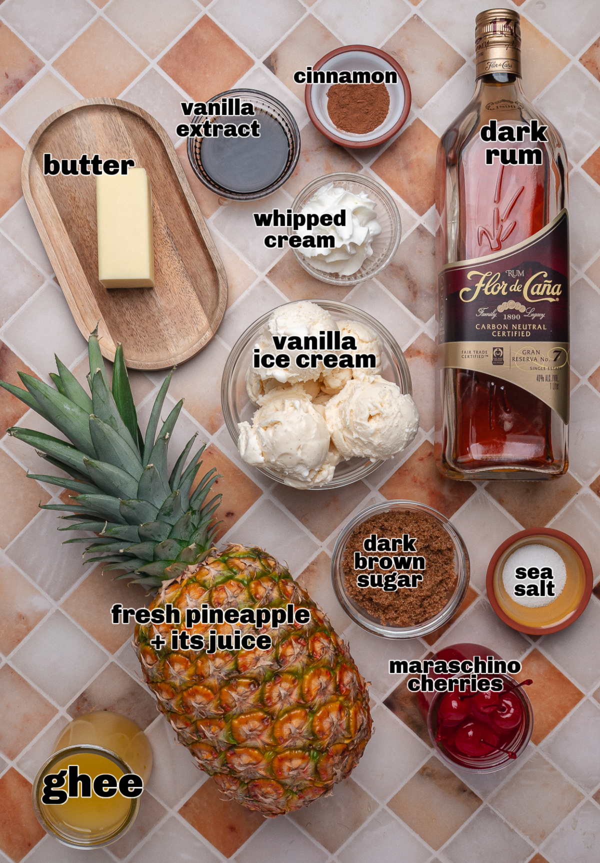 Ingredients for a grilled pineapple sundae including fresh pineapple, dark rum, brown sugar, butter, ghee, vanilla ice cream, and whipped cream