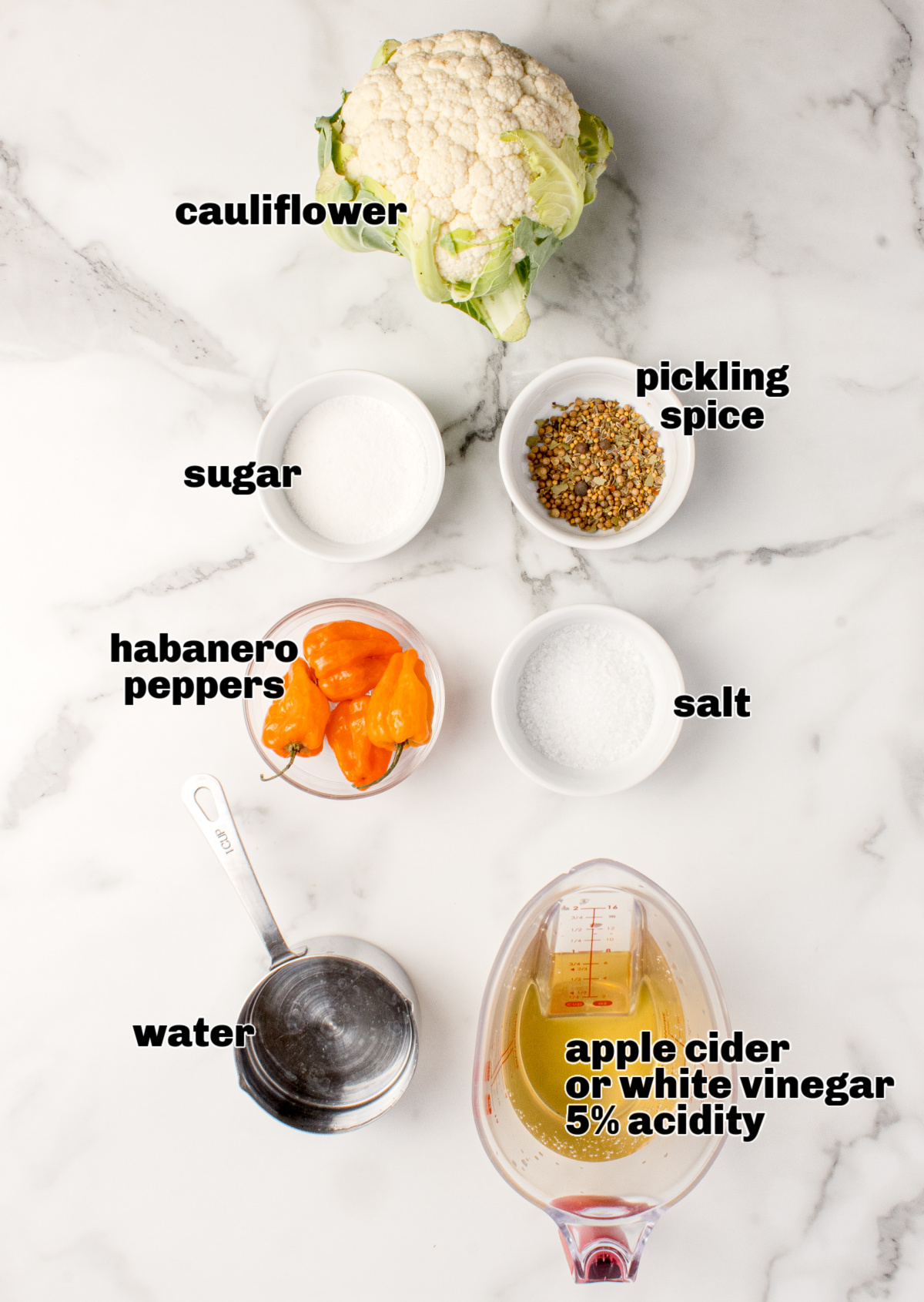 Ingredients for hot pickled cauliflower including cauliflower, habaneros, pickling spice, vinegar, salt, sugar, and water