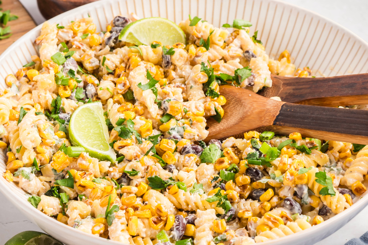 Mexican street corn pasta salad served as a creamy side dish with rotini, golden corn, black beans, cotija, and fresh cilantro