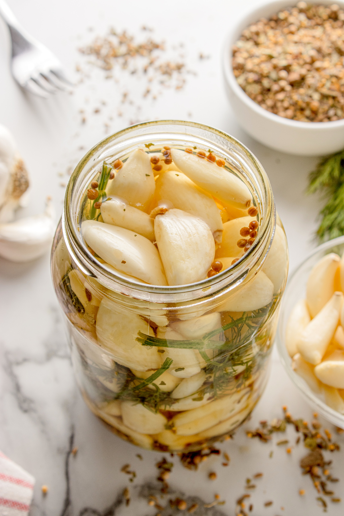 Pickled Dill Garlic in a mason jar with dill and pickling spice