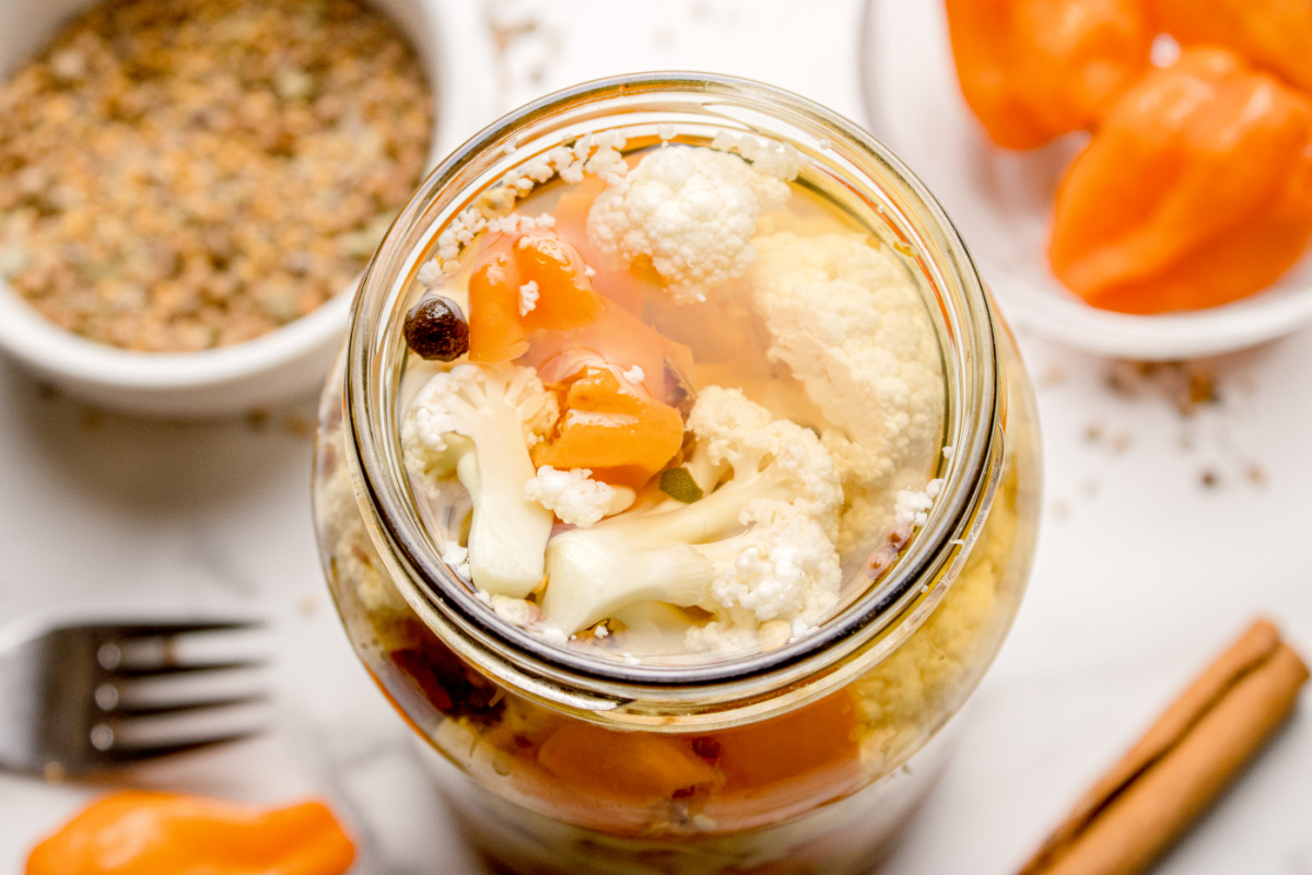 Hot pickled cauliflower in vinegar brine with habanero slices and whole spices