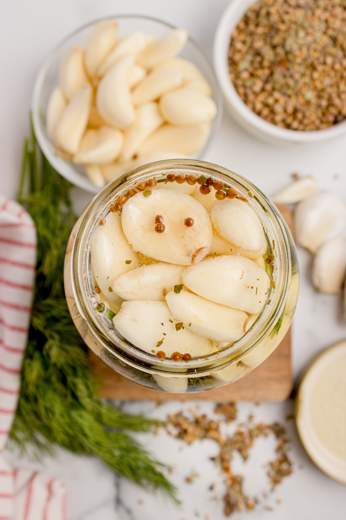 Overhead view of refrigerator pickled garlic cloves in brine