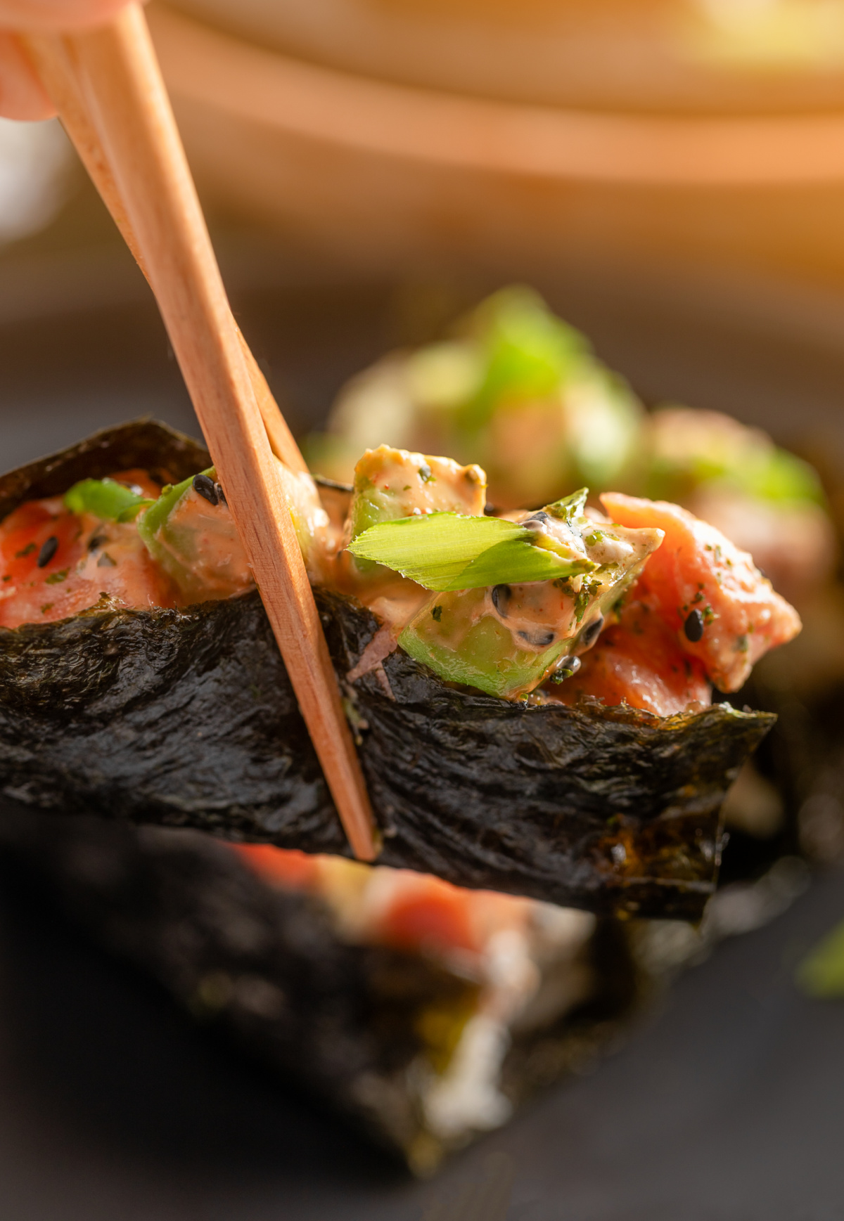 Nori-wrapped sushi bake topped with salmon, avocado, and spicy mayo