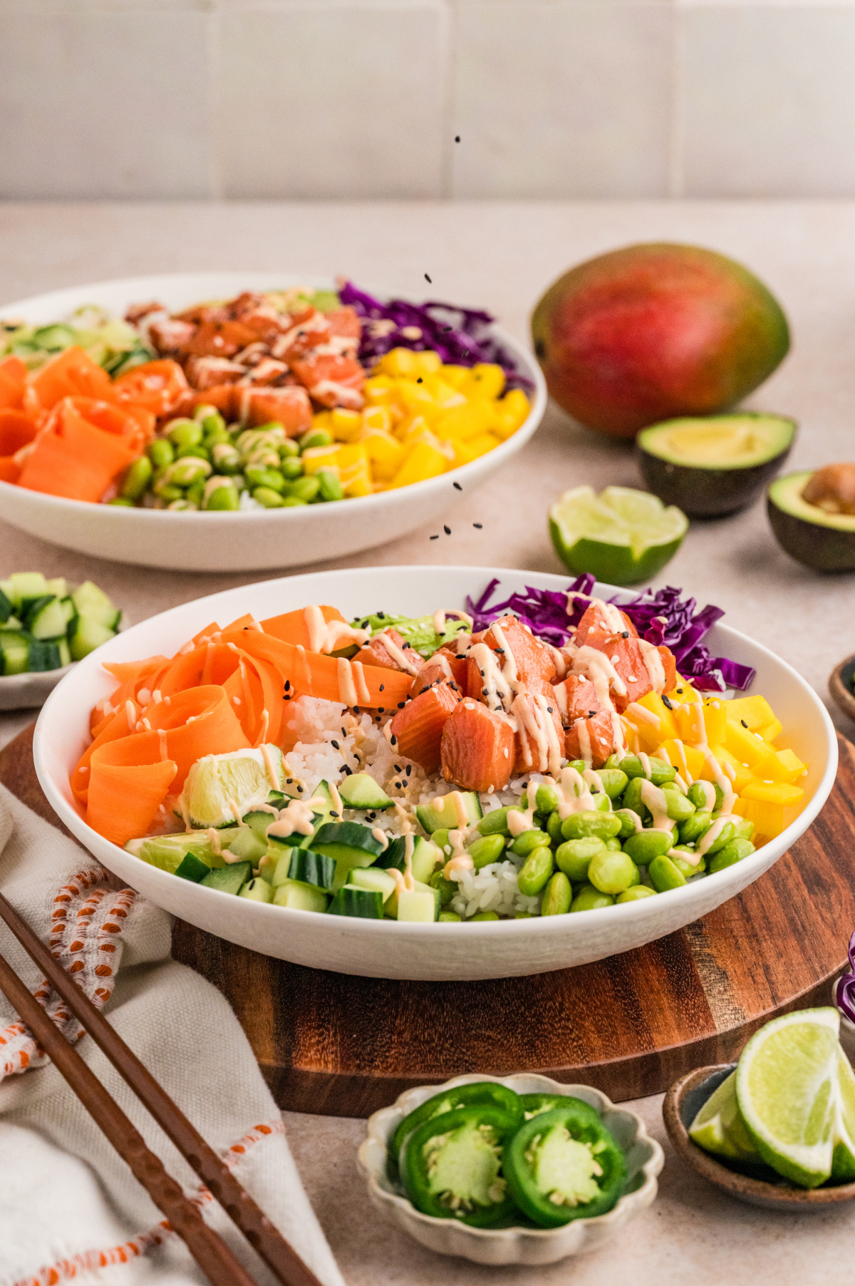 Salmon poke bowl served with sushi rice, marinated salmon, mango, edamame, cucumber, and avocado
