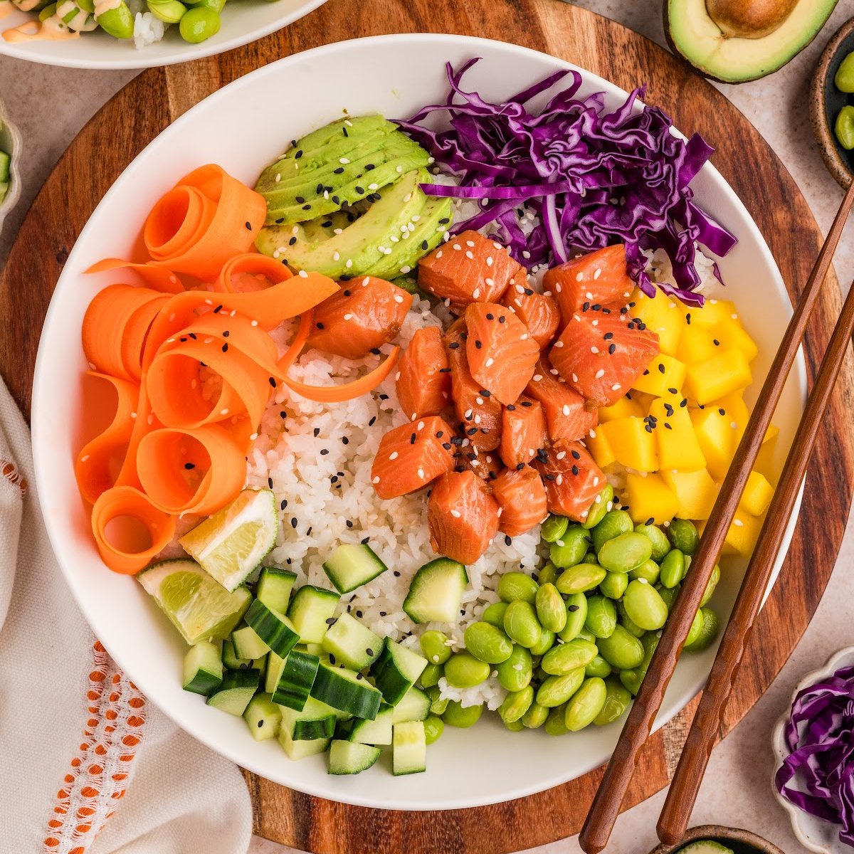 Salmon poke bowls made at home with sushi-grade salmon, rice, mango, avocado, and colorful fresh toppings