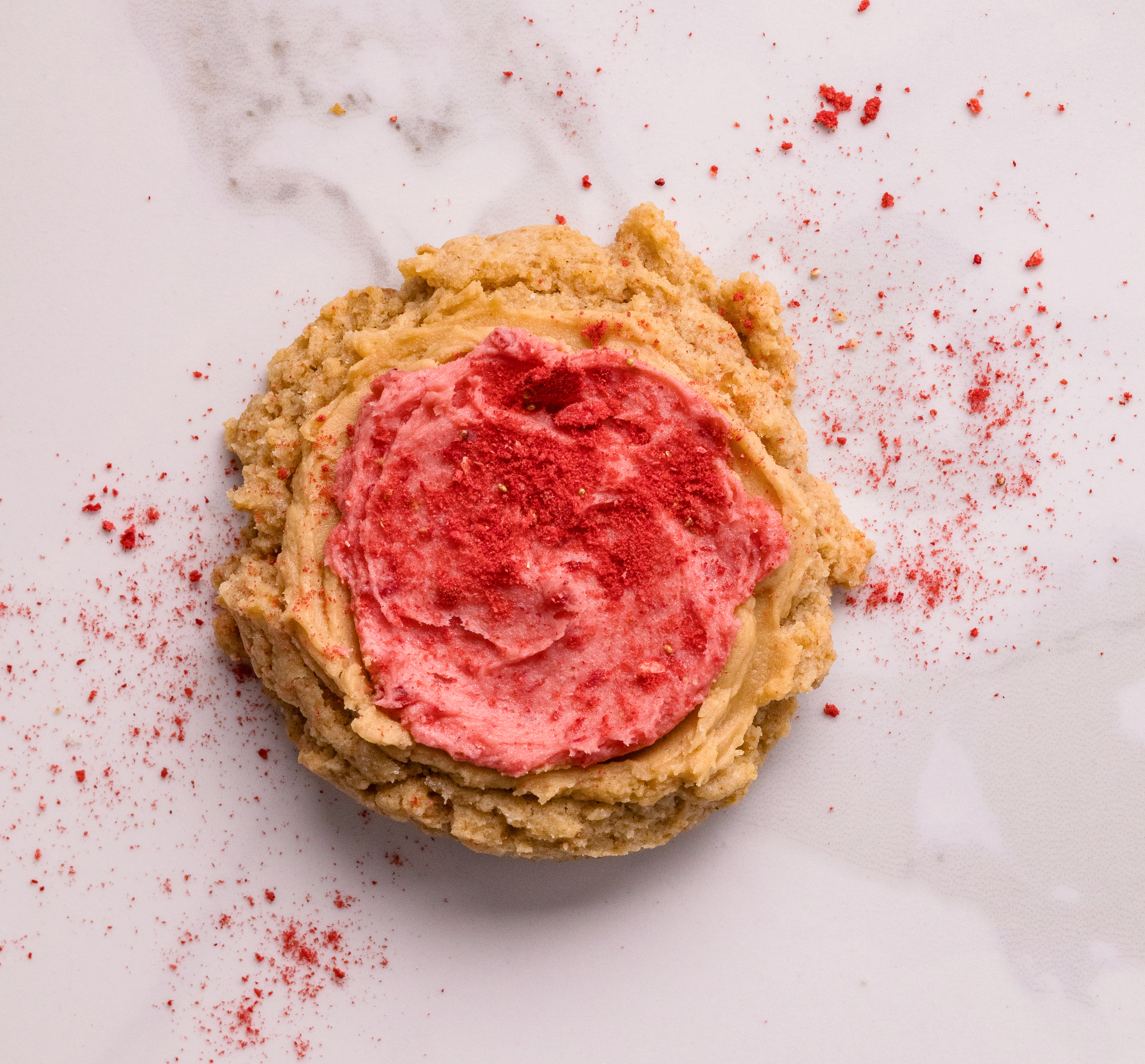 Biscoff butter cookie with strawberry frosting and strawberry powder on top