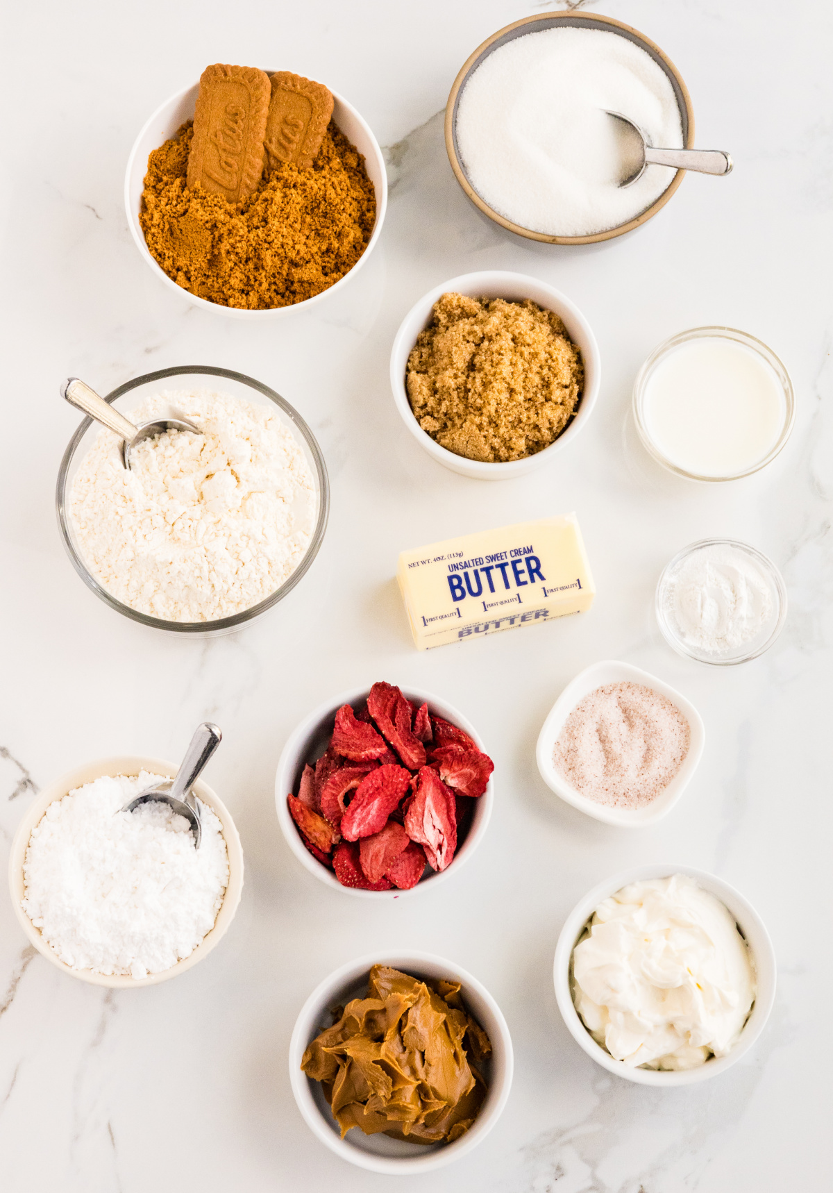 ingredients for Biscoff butter cookies including Biscoff cookies, flour, butter, and freeze-dried strawberries