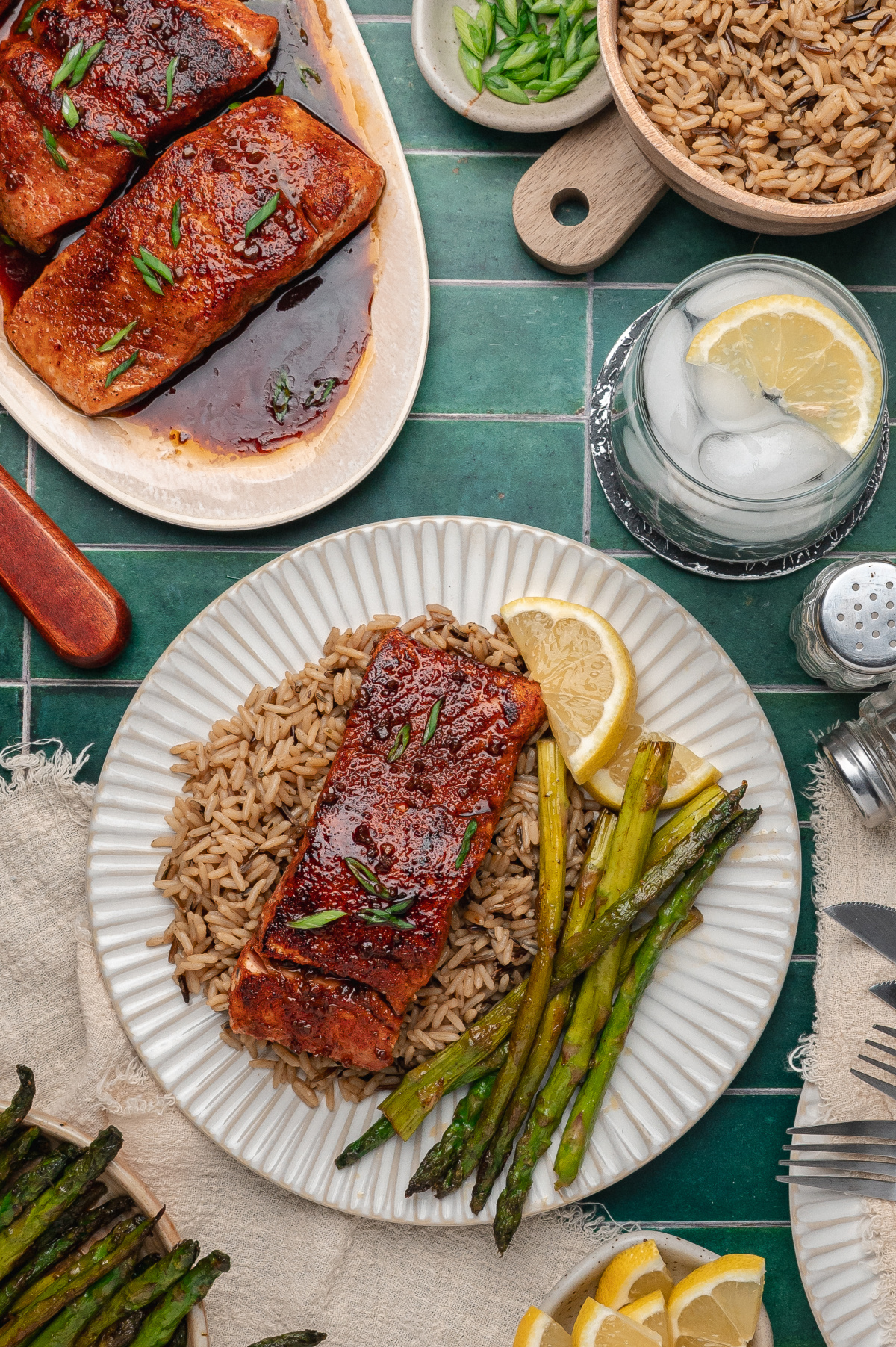 bourbon glazed salmon served with rice and roasted asparagus on a dinner plate
