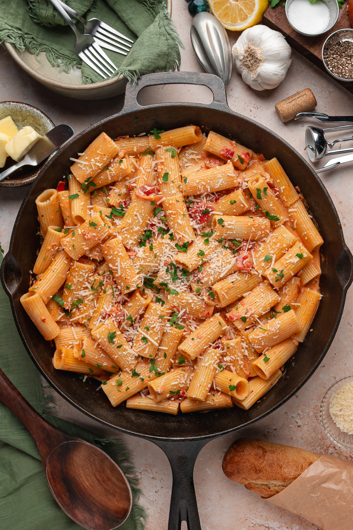 Calabrian chili rigatoni in creamy tomato sauce served in a cast iron skillet with Parmesan and parsley