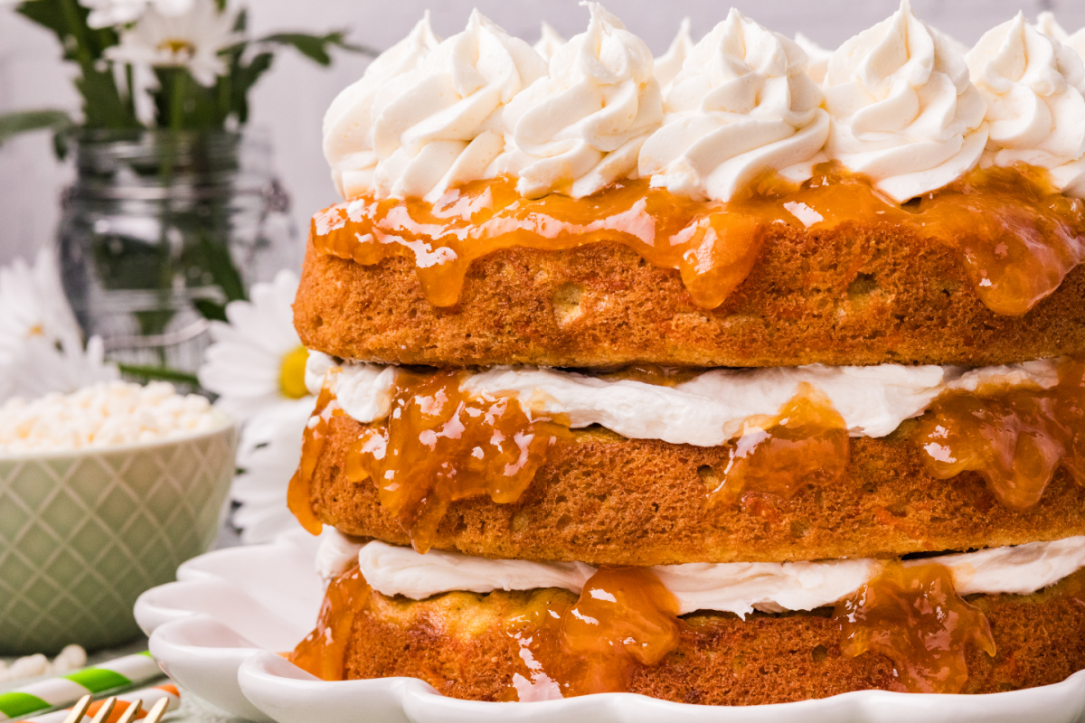 Side view of Carrot Cake with Apricot Filling and White Chocolate Cream Cheese Frosting showing layered cake and apricot preserves between layers