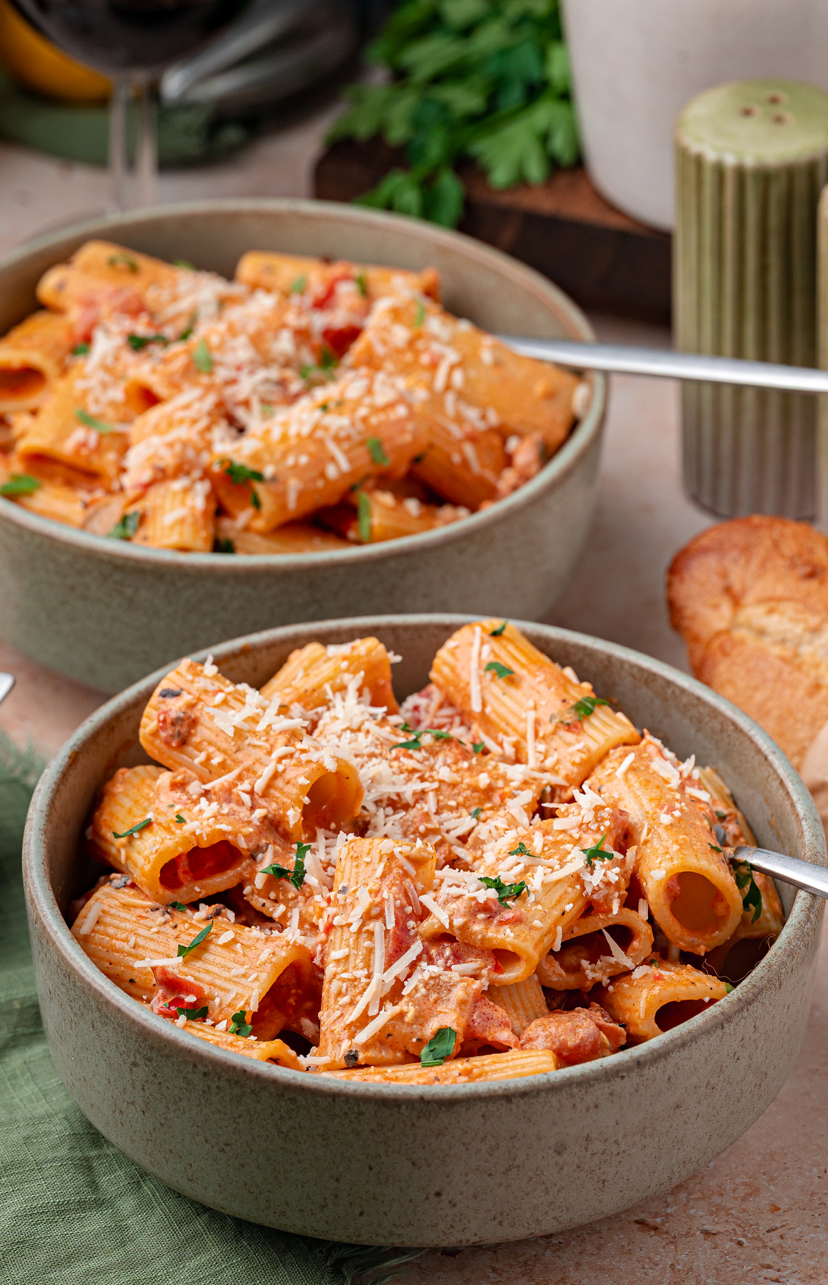 Bowls of creamy rigatoni pasta with Calabrian chilis, Parmesan, and parsley