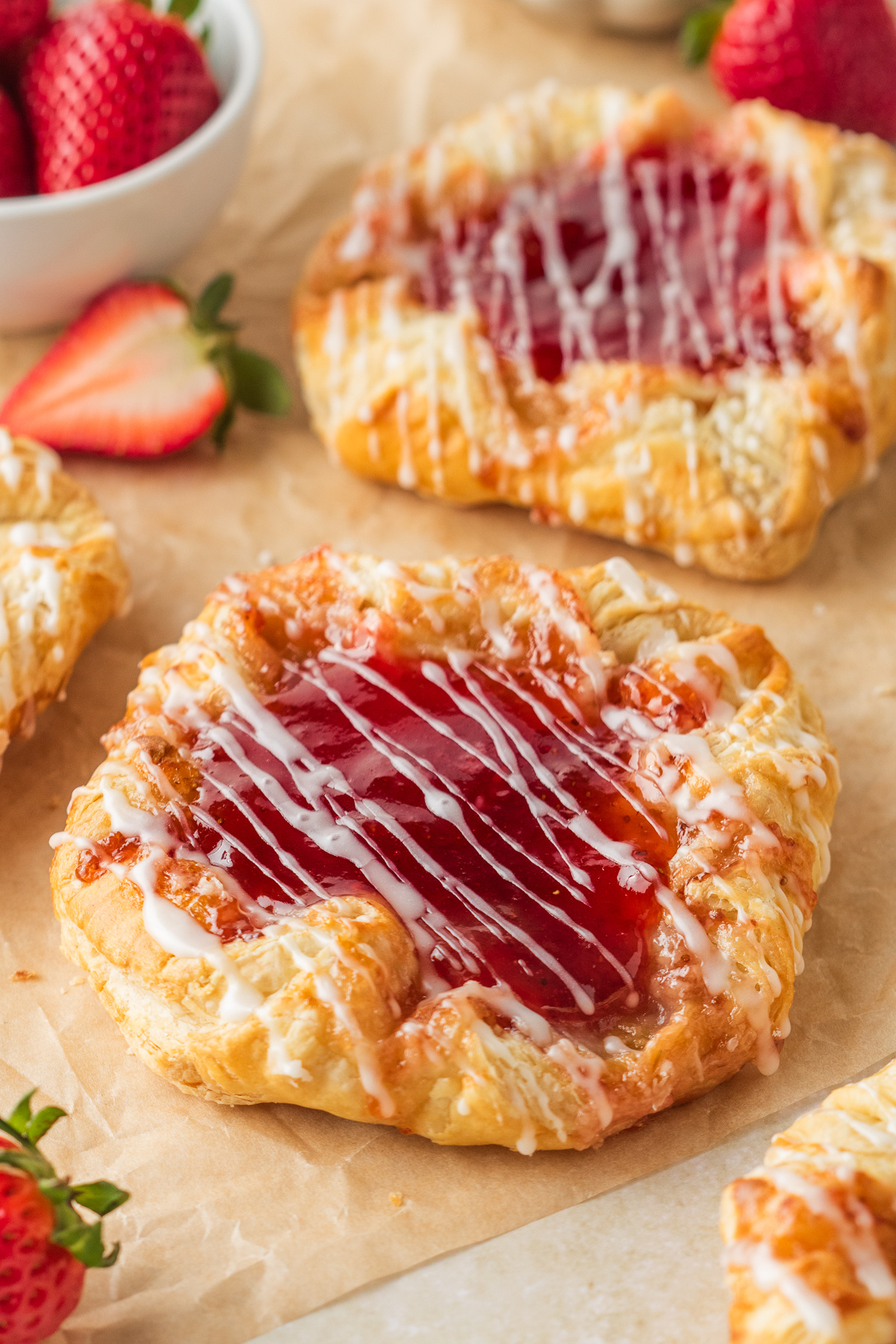 easy strawberry danish made with puff pastry and cream cheese filling topped with glaze