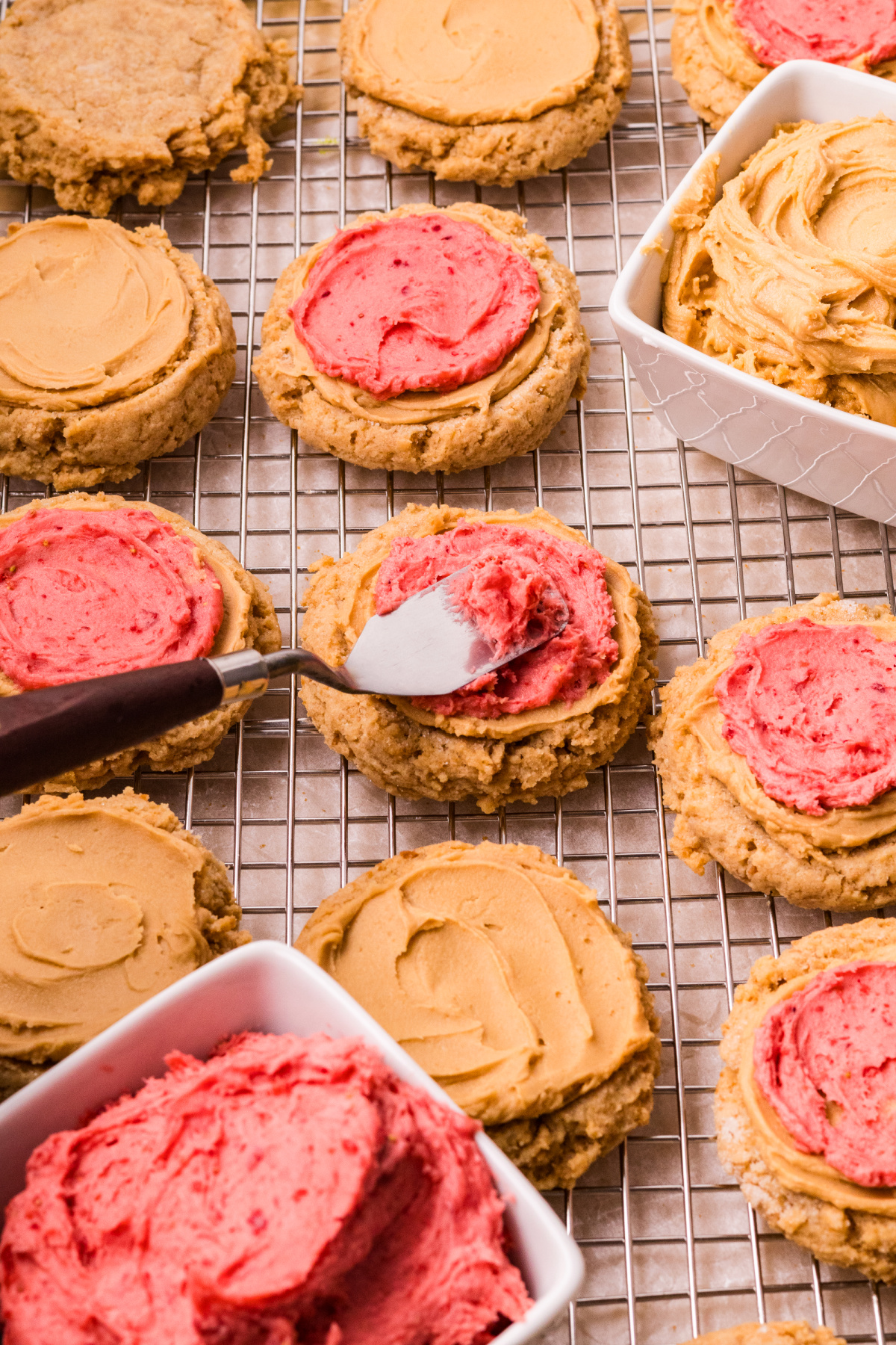 frosting Biscoff butter cookies with cookie butter and strawberry frosting
