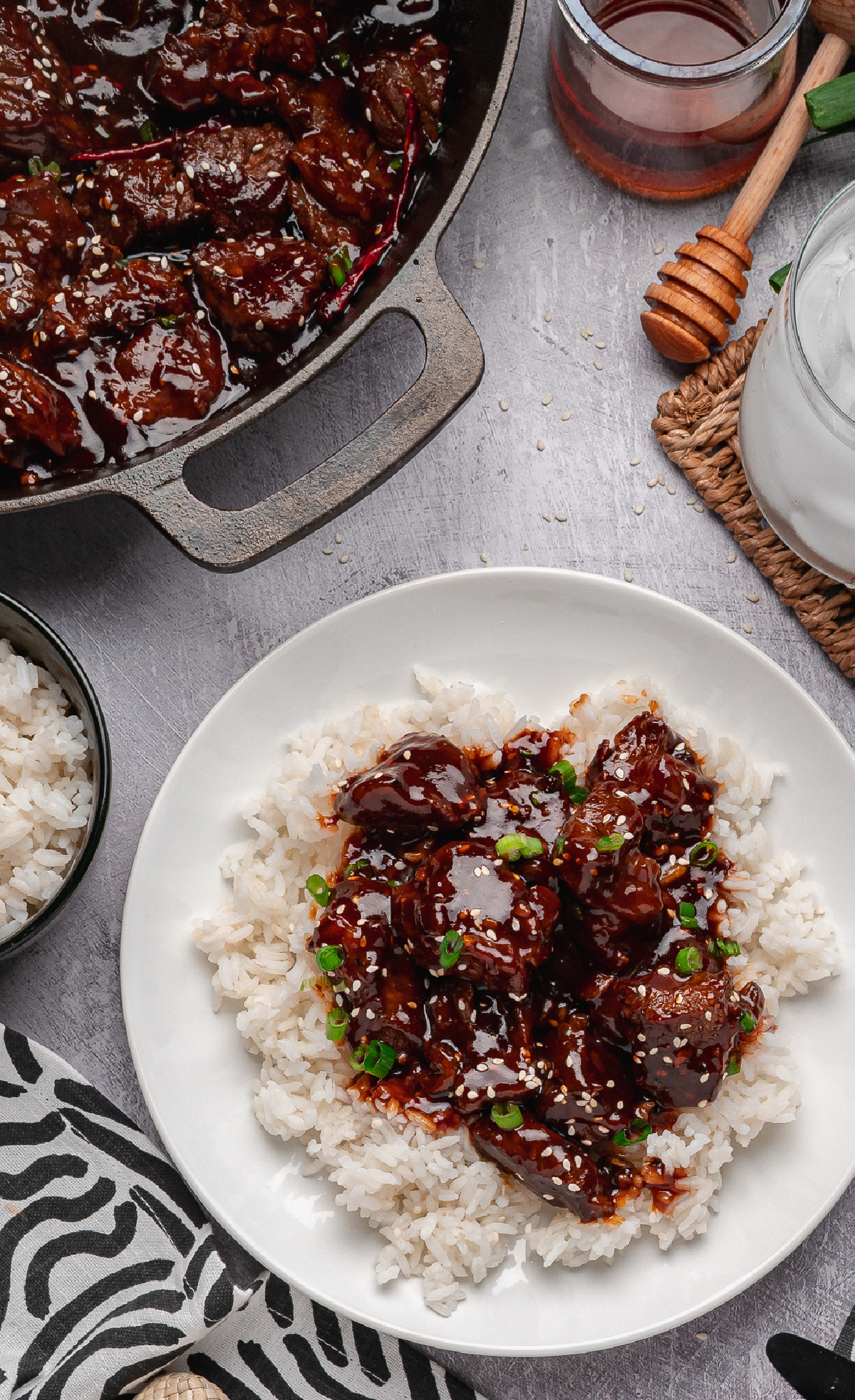 gochujang steak bites served over white rice with sesame seeds and green onions