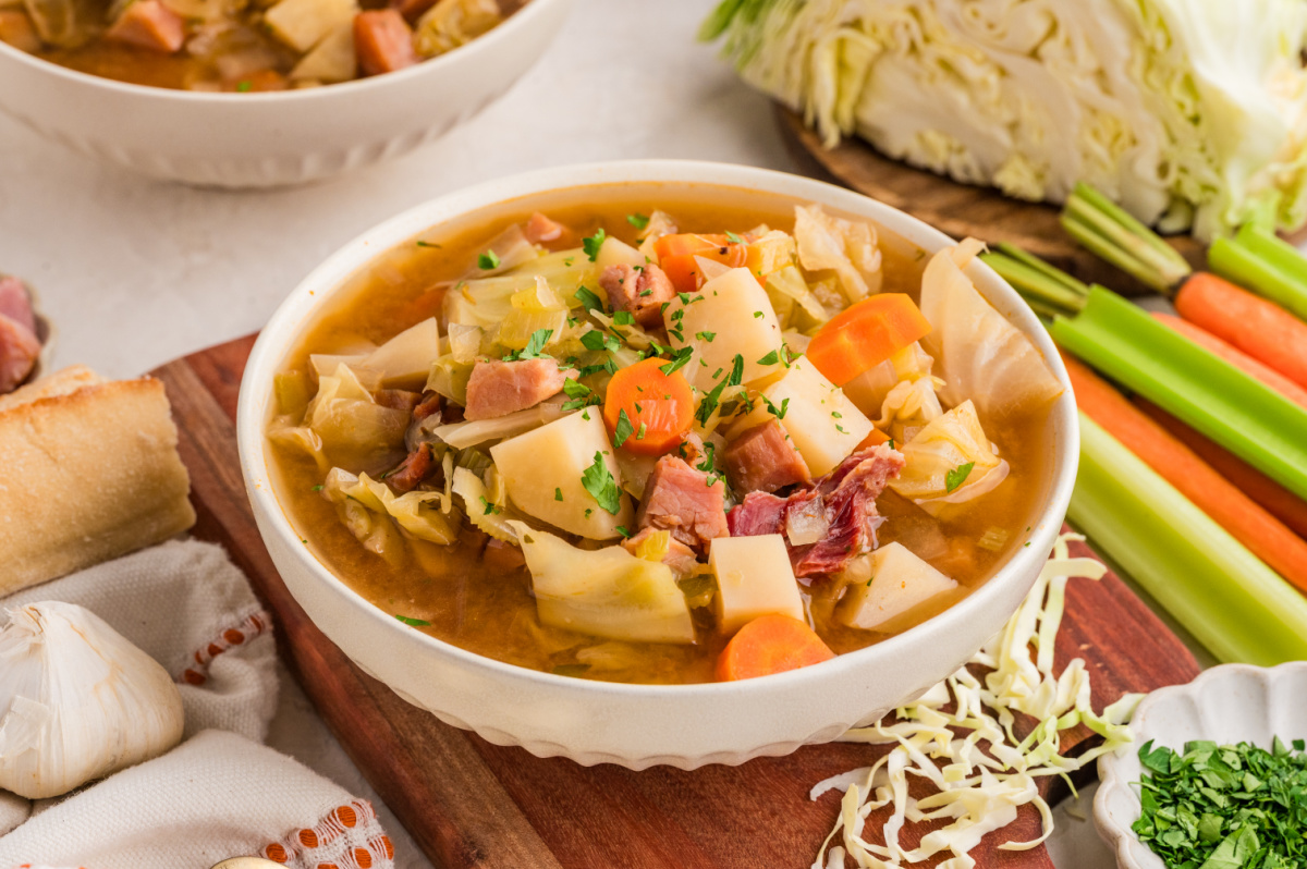 Ham and cabbage soup with potatoes, carrots, cabbage, and ham in a brothy bowl