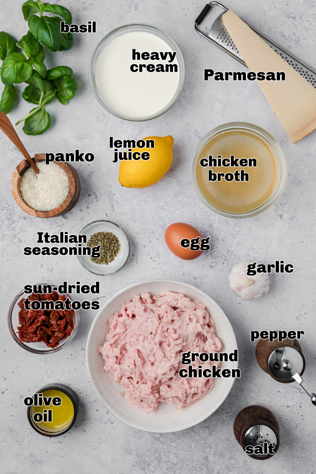 Ingredients for creamy chicken meatballs including ground chicken, heavy cream, Parmesan, sun-dried tomatoes, garlic, panko, and Italian seasoning