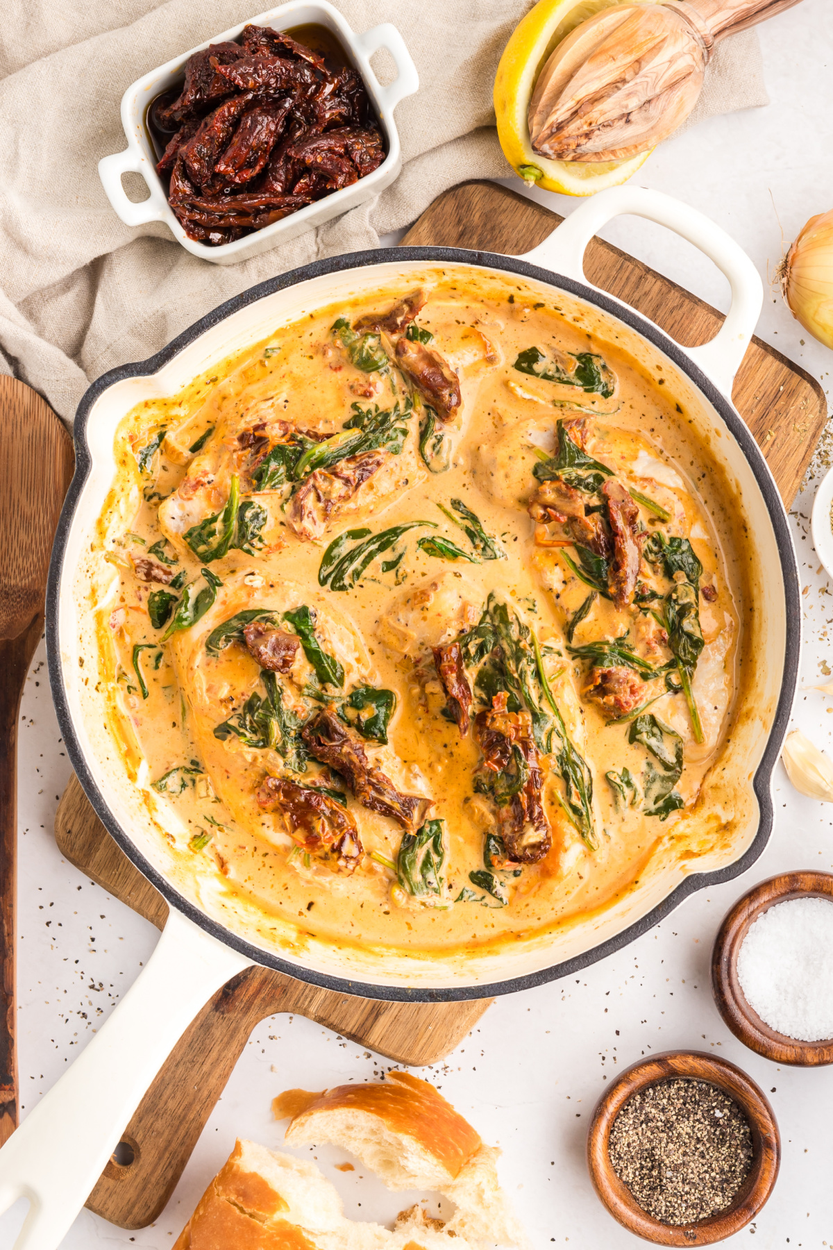 Marry Me Tuscan Chicken in creamy parmesan sauce with sun-dried tomatoes and spinach in skillet