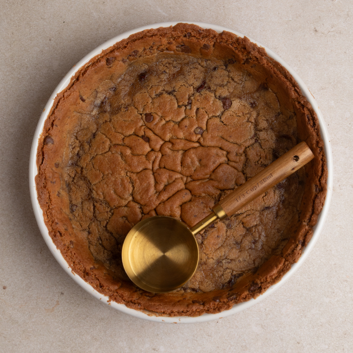 baked chocolate chip cookie dough crust pressed into a round baking dish