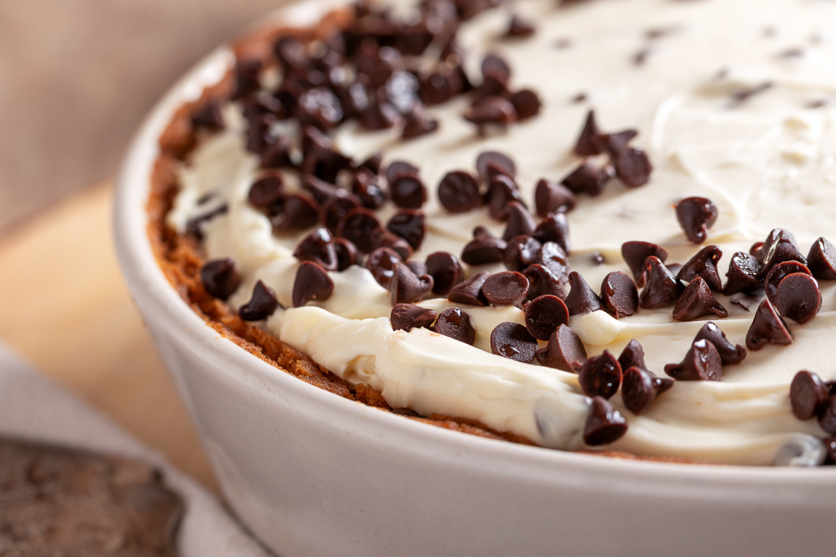 close up of no-bake cheesecake filling with mini chocolate chips in a cookie dough crust