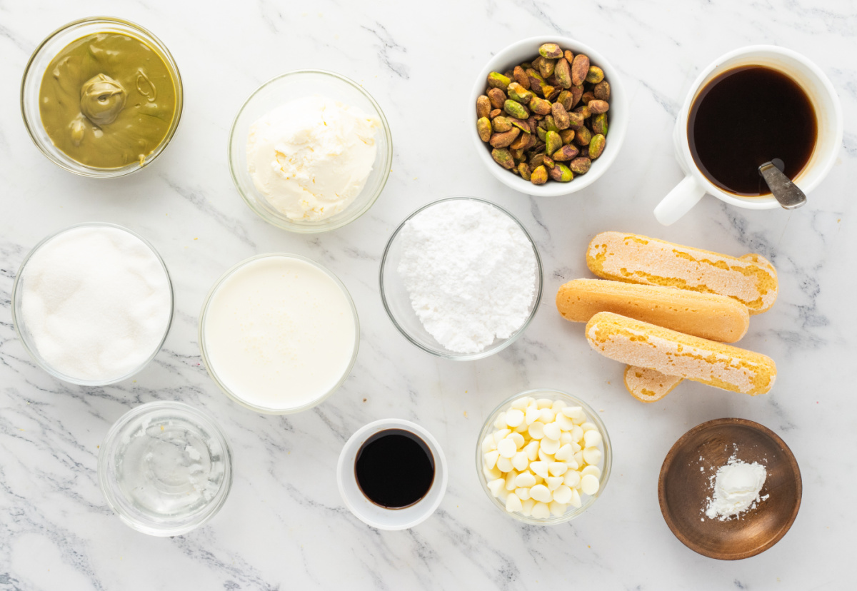 ingredients for pistachio tiramisu including mascarpone pistachios ladyfingers coffee white chocolate and heavy cream