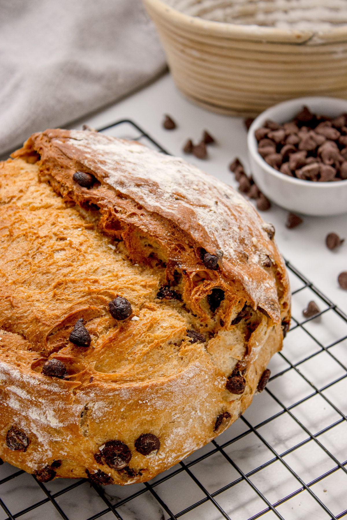 Chocolate Chip Artisan Bread sliced open on a cooling rack showing golden crust and melted chocolate chips inside