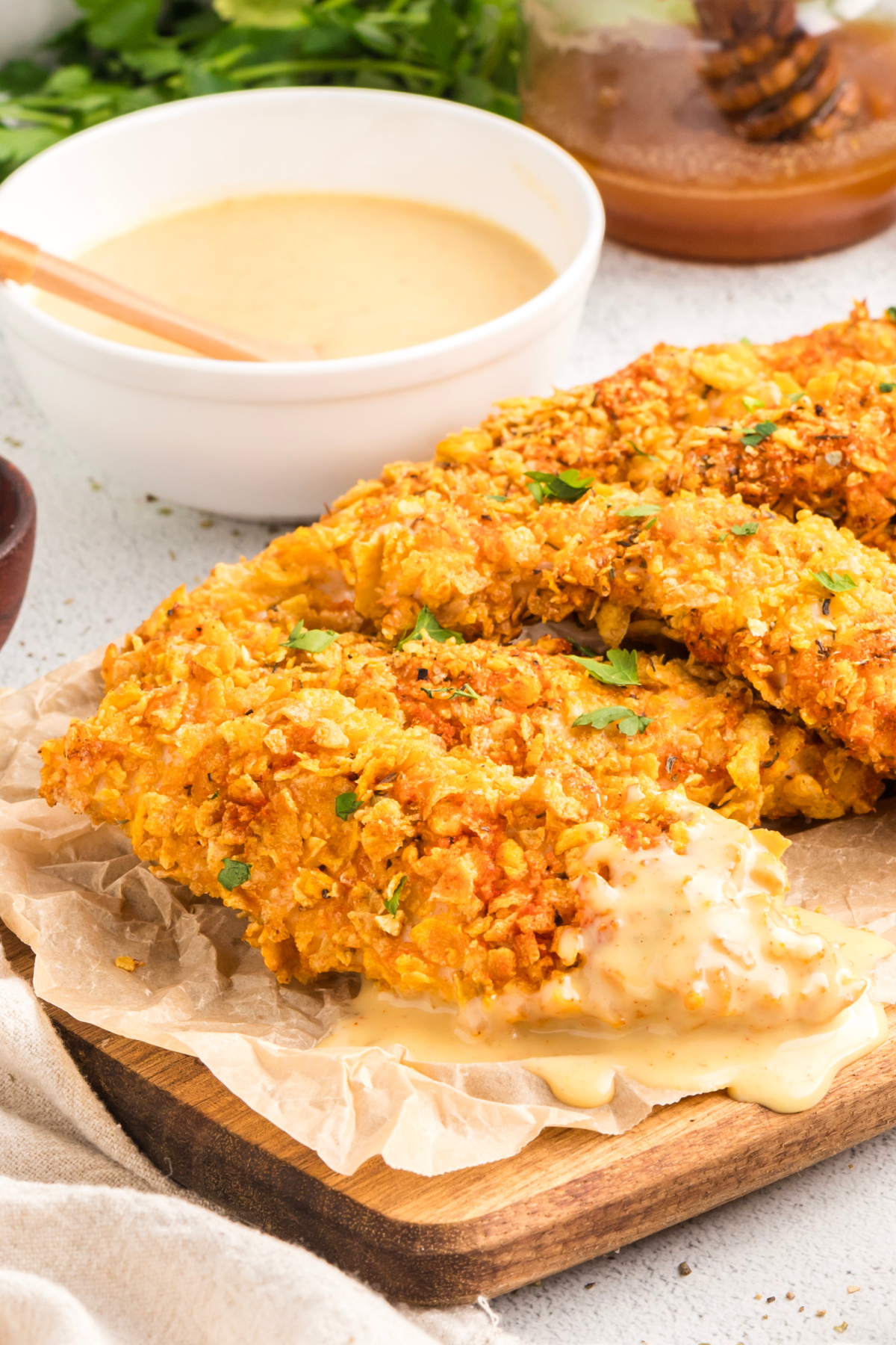 Crispy baked chicken tenders with crunchy cornflake coating served with homemade honey mustard dipping sauce