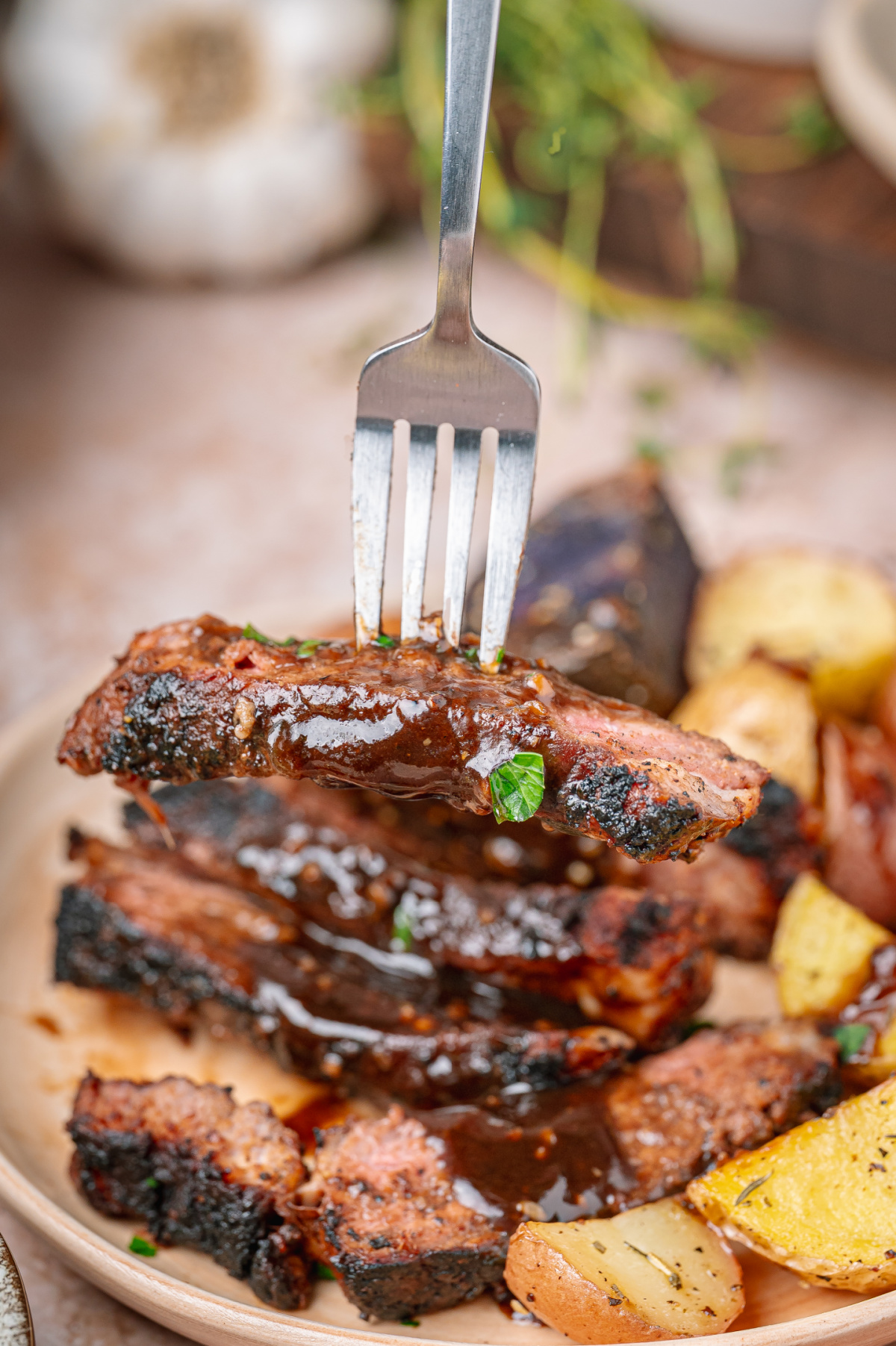 Dark stout pan sauce spooned over sliced steak with a charred cocoa spice crust.