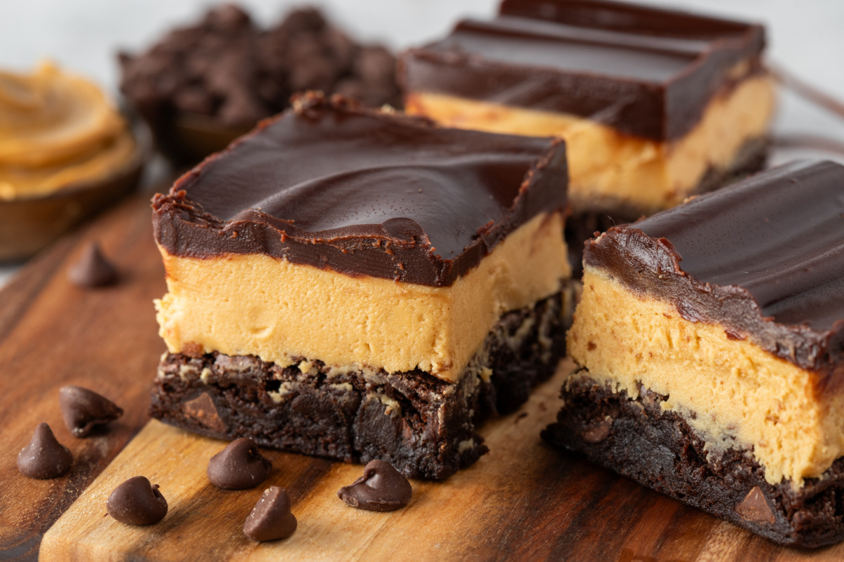 Fudgy layered Buckeye brownies with thick peanut butter filling and chocolate ganache