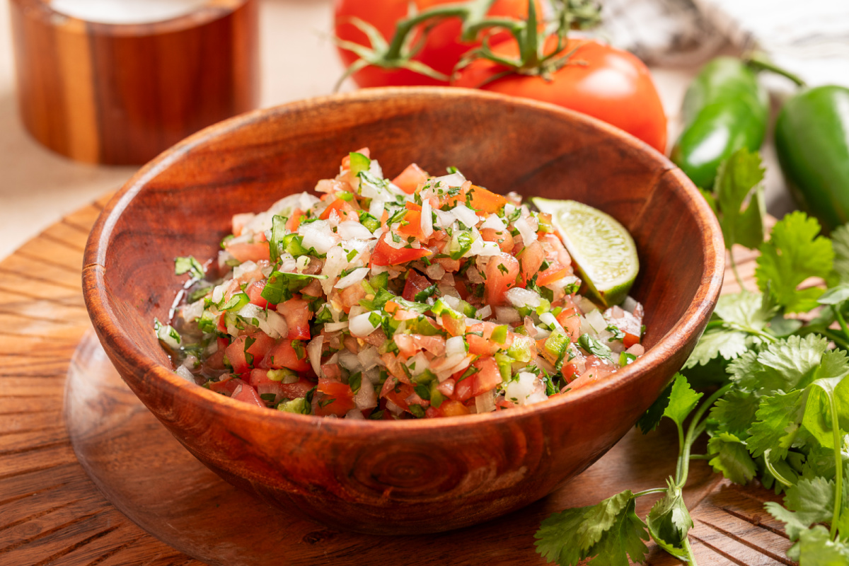 Fresh homemade pico de gallo with cilantro, jalapeño, and lime juice Homemade pico de gallo in a wooden bowl with seeded tomatoes, cilantro, jalapeño, onion, and fresh lime