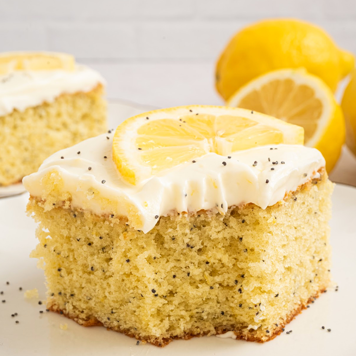 Lemon poppy seed sheet cake with cream cheese frosting topped with lemon slices