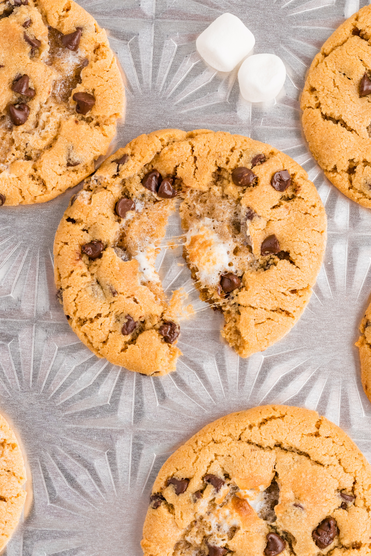 Melted Marshmallow Cookie Center Pull-apart peanut butter cookie with melted marshmallow stretching between the halves and mini chocolate chips throughout.
