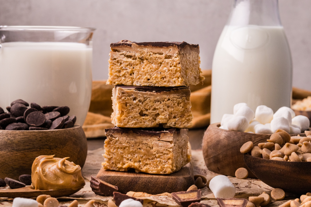 Stacked peanut butter marshmallow crunch bars with chewy cereal layers and chocolate peanut butter topping