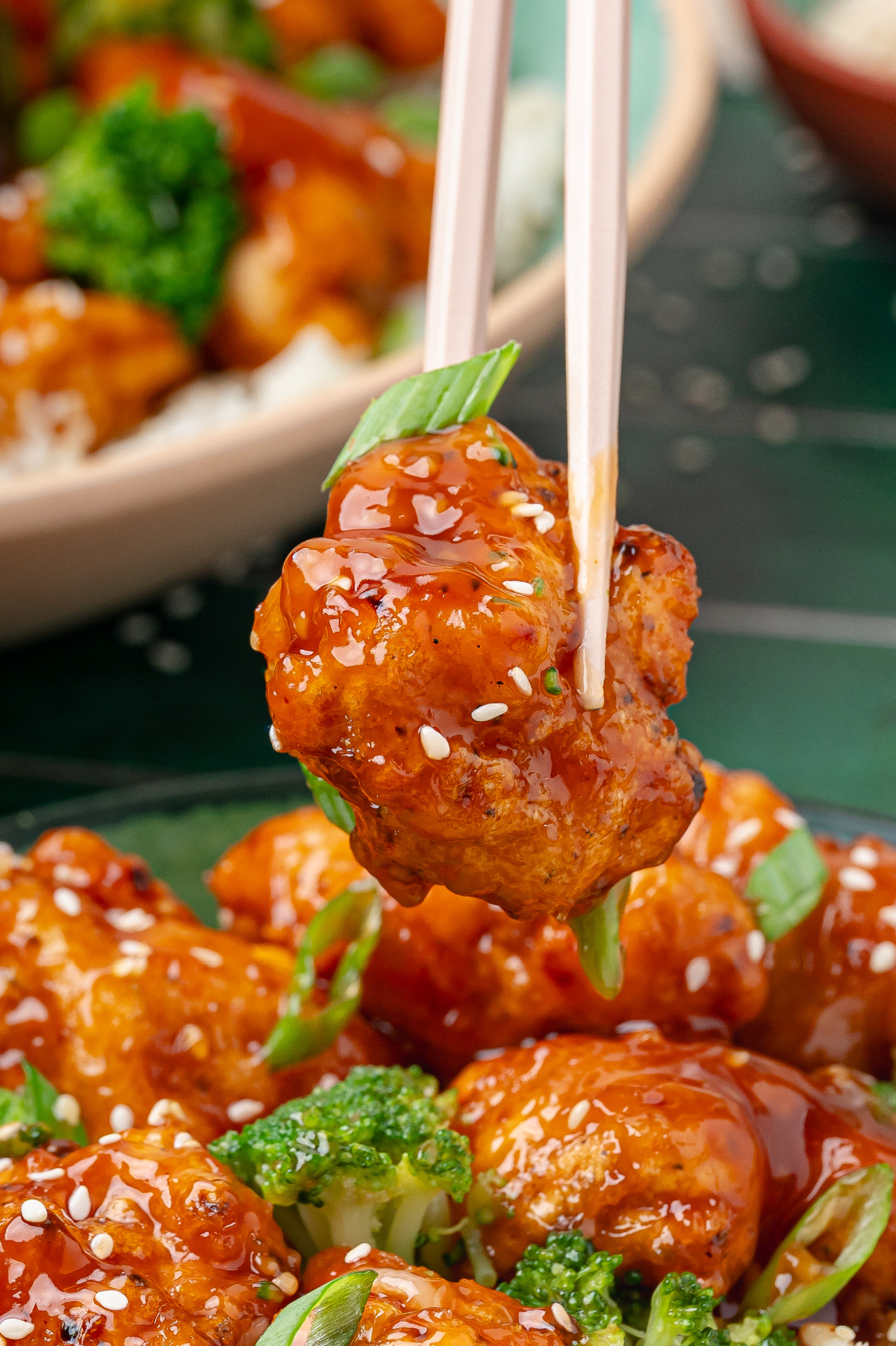 bite-of-orange-chicken-with-chopsticks
