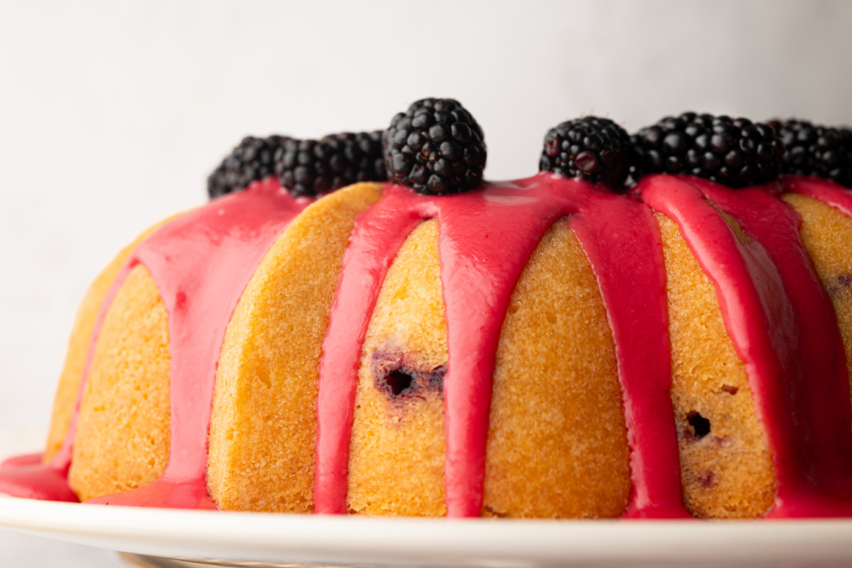 Fresh blackberry glaze setting on a lemon Bundt cake Fresh blackberry glaze dripping down the sides of a lemon Bundt cake topped with blackberries