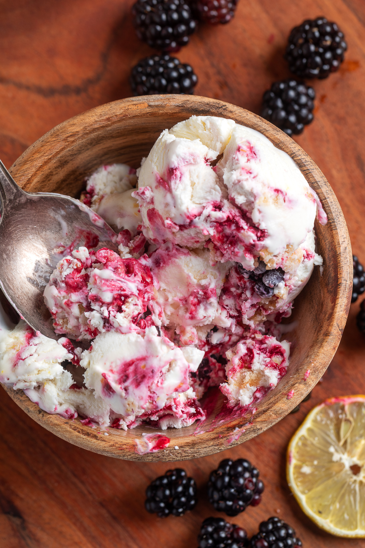 Creamy homemade blackberry lemon ice cream with jam-like blackberry ribbons, fresh lemon flavor, and buttery shortbread crumble. Homemade blackberry lemon ice cream with thick blackberry swirls and buttery shortbread crumble served in a wooden bowl.