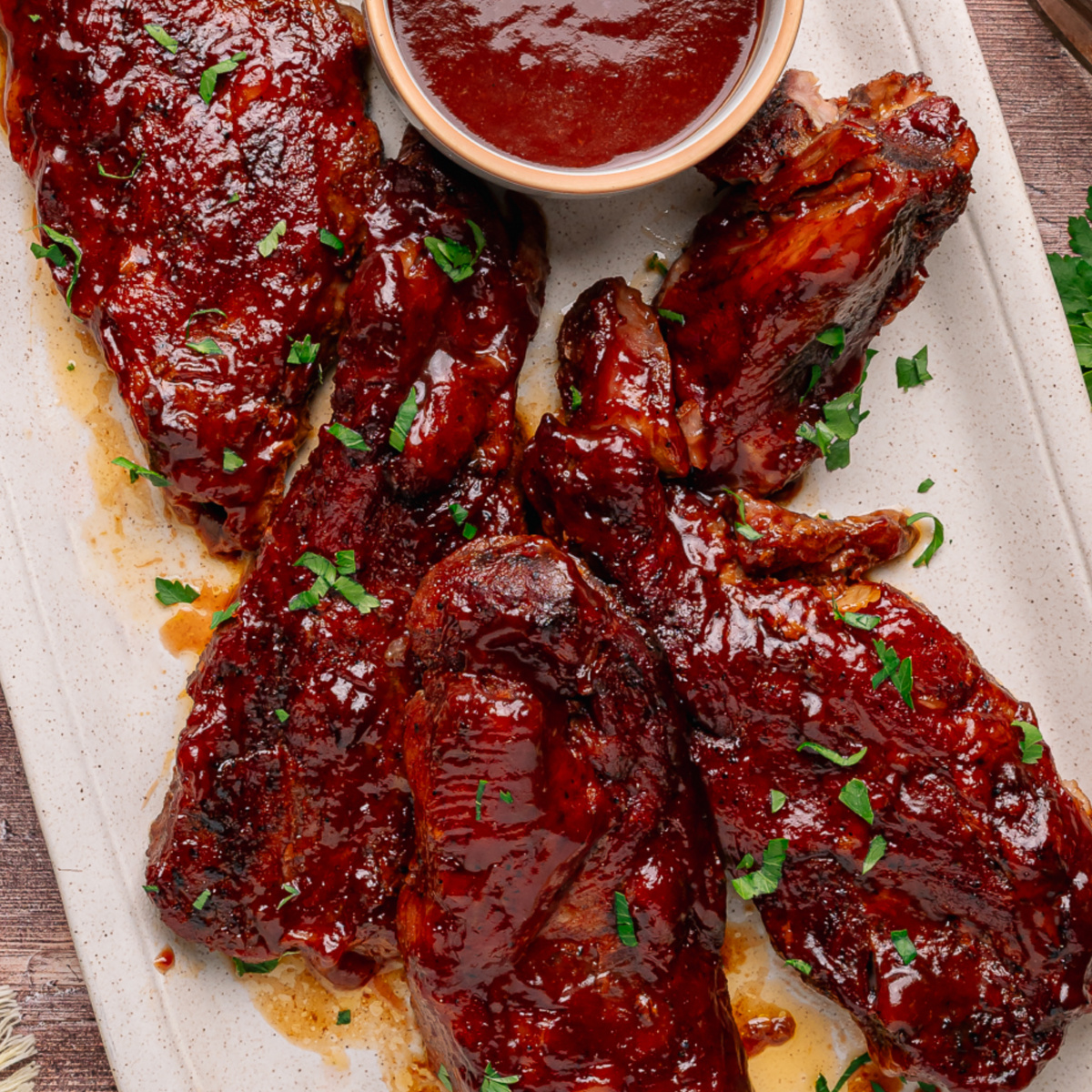 Bourbon peach country style ribs glazed with peach bourbon barbecue sauce and served with extra sauce on the side